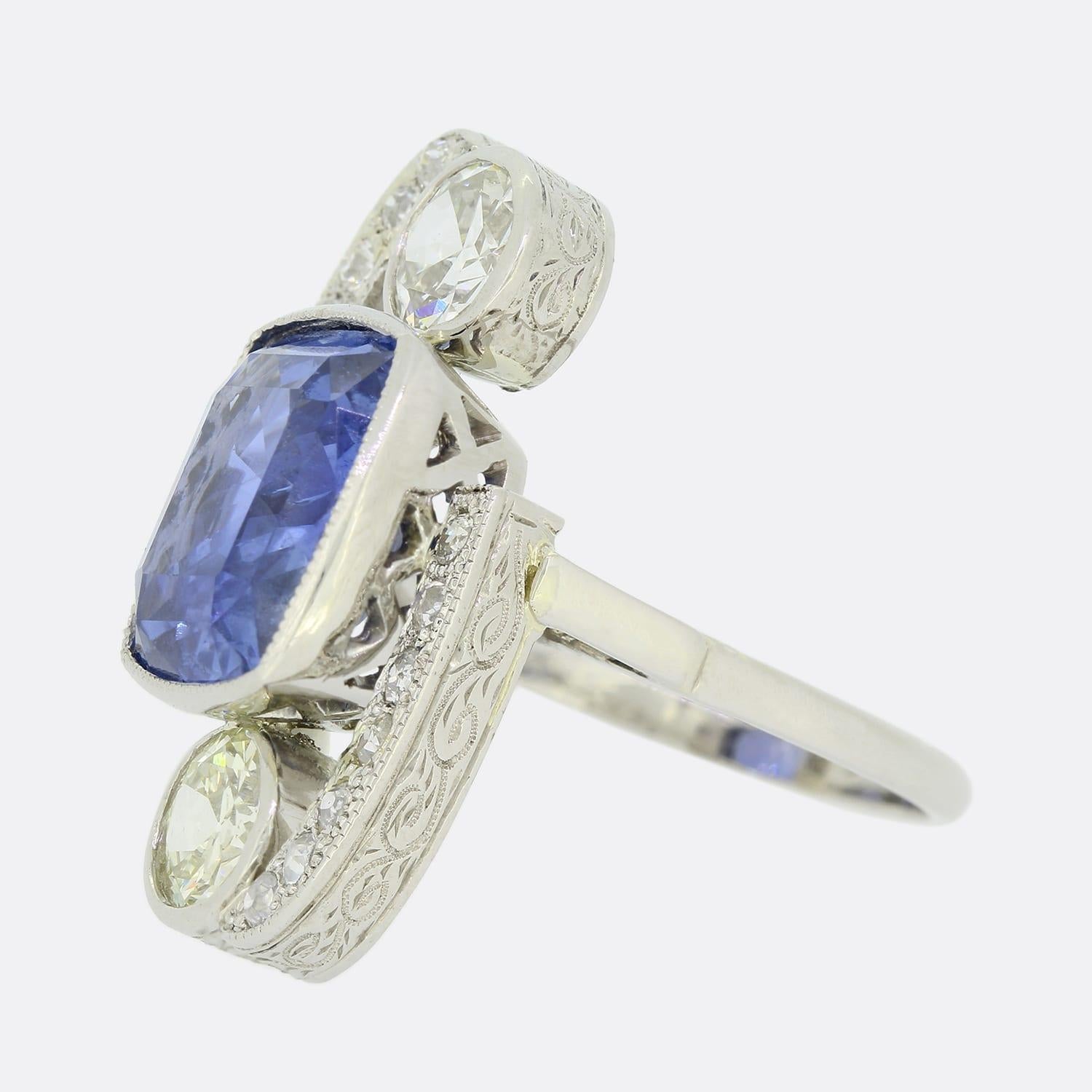 This is a wonderful sapphire and diamond ring from the Art Deco period. The cushion cut sapphire is untreated, of ceylon origin and a highly desirable cornflower blue tone. There is a stunning old cut diamond set both above and below the sapphire