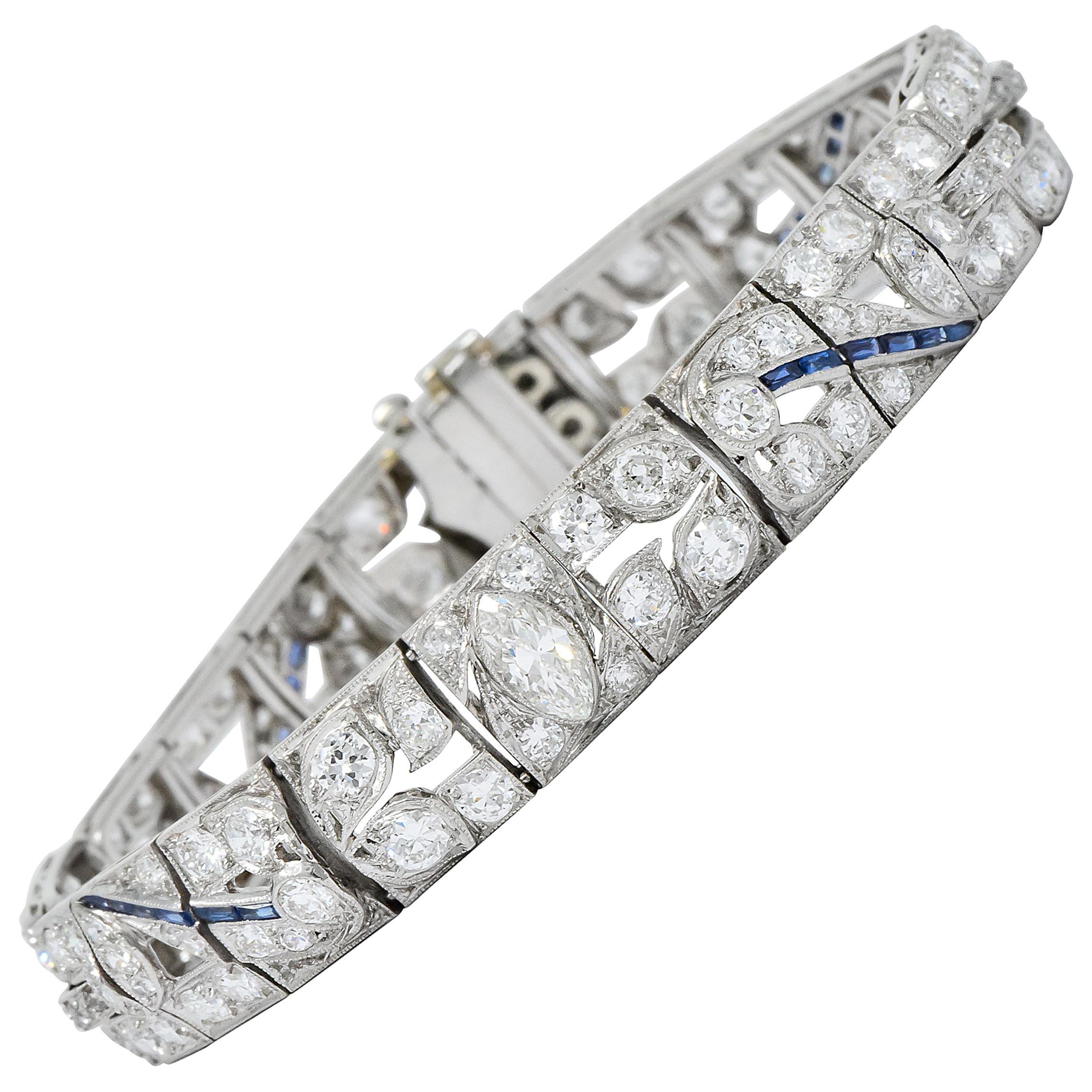 Link bracelet is designed with a pierced and scrolling floral motif with decorative milgrain detail

Set throughout by round brilliant and single cut diamonds weighing in total approximately 9.06 carats total; G/H color with VS to SI
