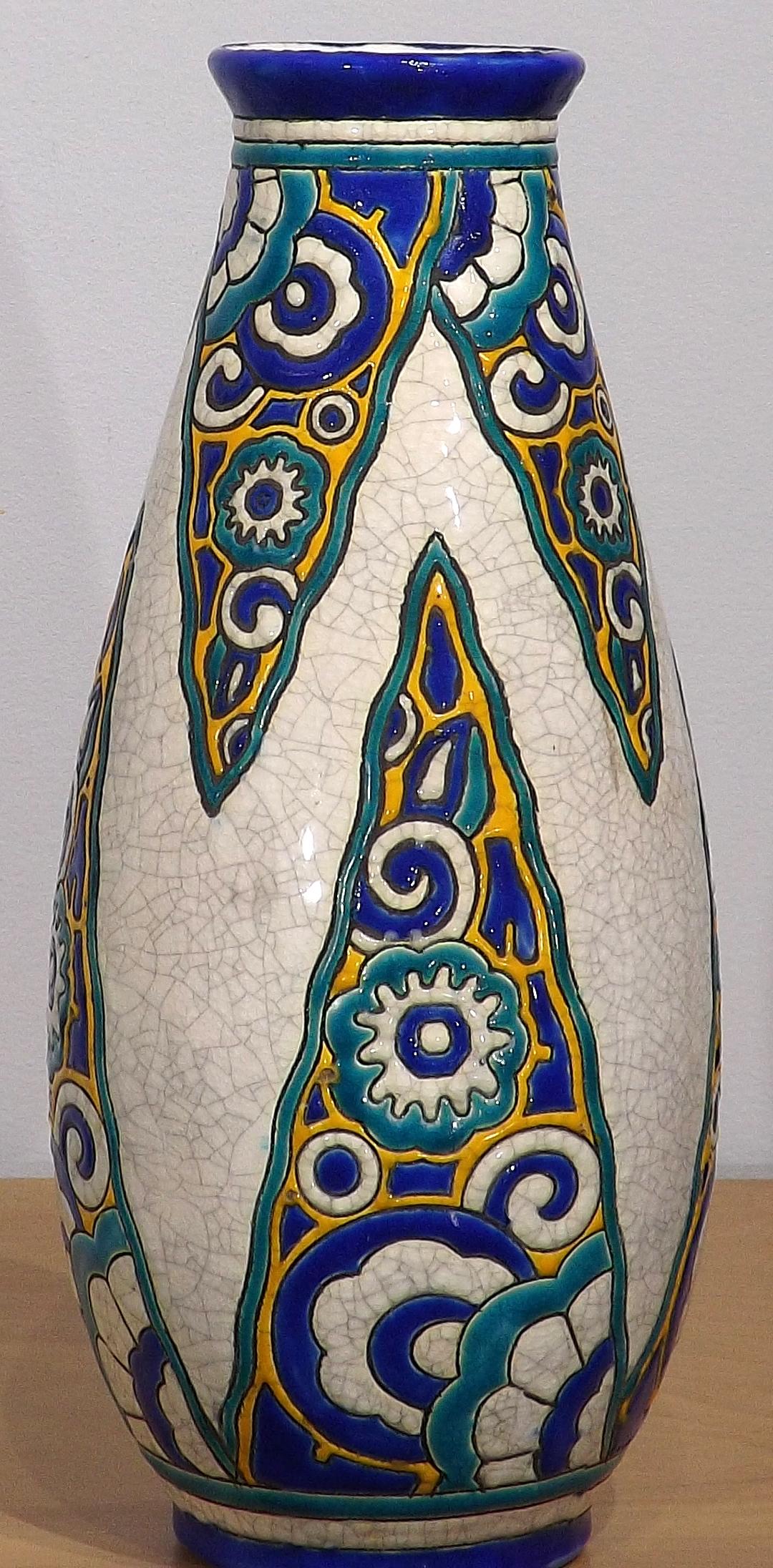 A beautiful hand-painted 12 3/4 inch Boch Freres Keramis vase decorated with abstract designs painted in rich cobalt blues and yellows. The background is the famous white crazing that Boch Freres is known for. Gobs of oozing paint, glossy and wet
