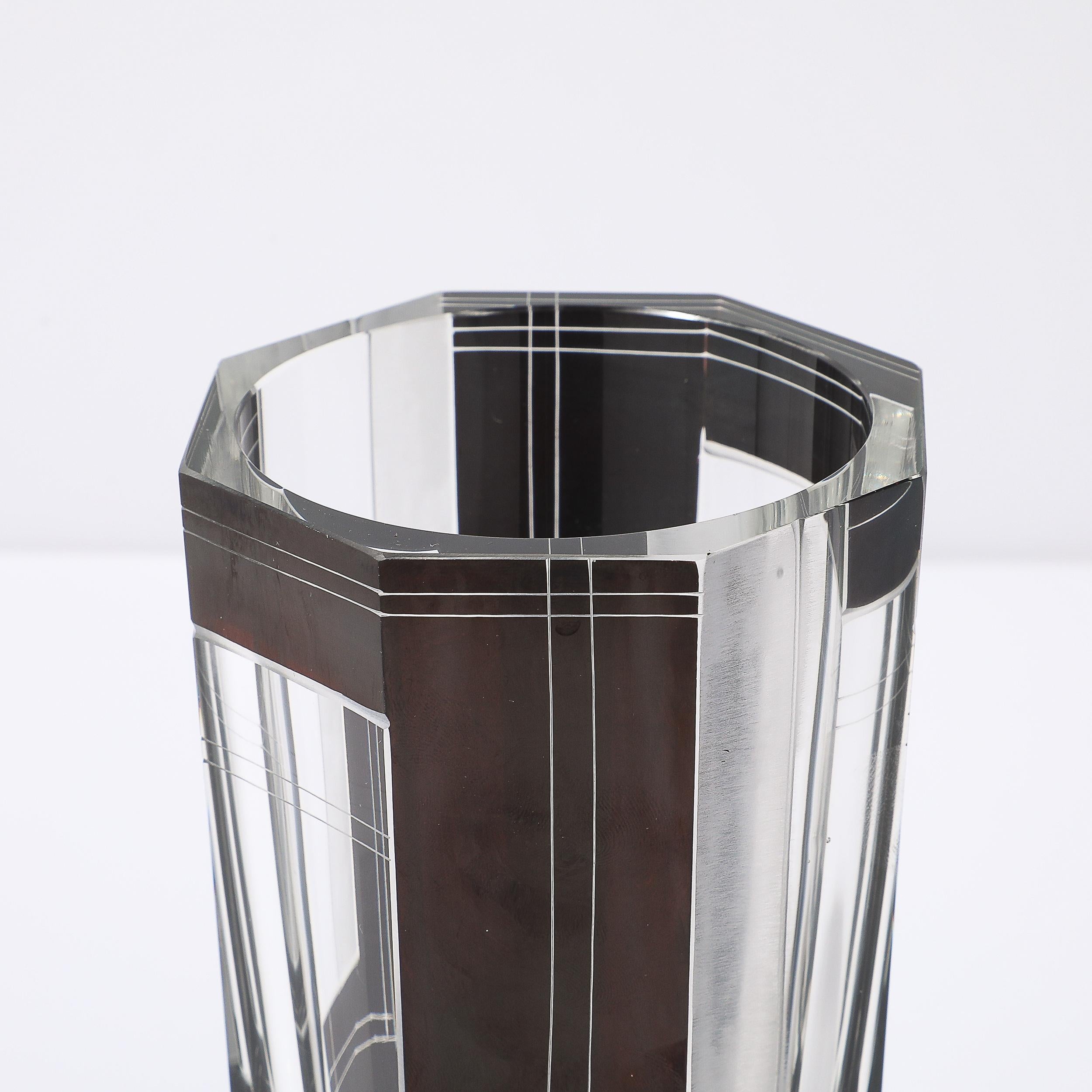 This striking Art Deco black glass vase, designed by Karl Palda in Czechoslovakia circa 1935, showcases the geometric elegance and meticulous craftsmanship emblematic of the period. The vase features a bold acid-etched design, a hallmark of Palda's