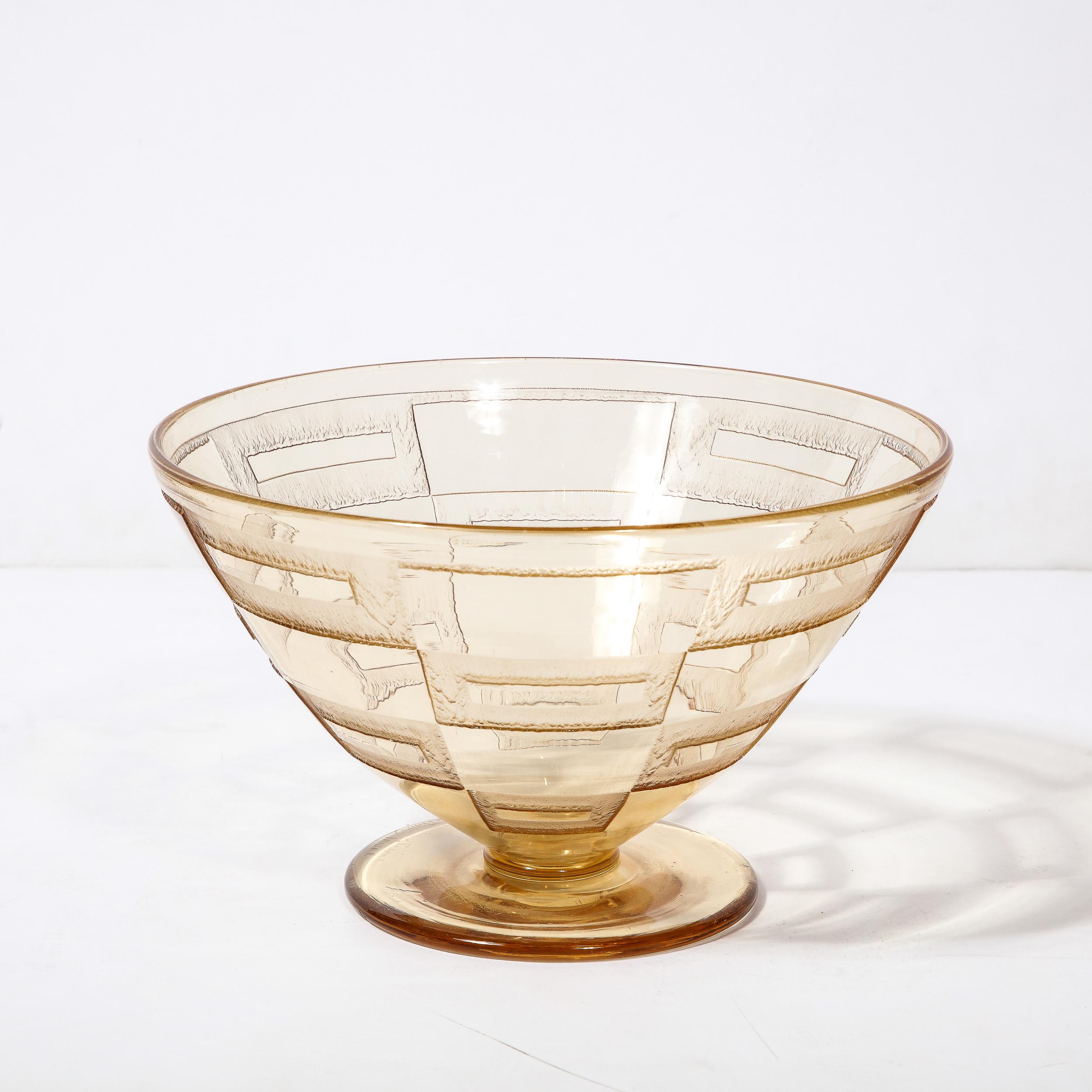 This Art deco Acid Etched Centerpiece bowl by the esteemed Art Glass Maker Daum originates from France, Circa 1930. Exquisite in all degrees, this radiant centerpiece features a gracefully tapered silhouette with a wide opening, smooth and subtly