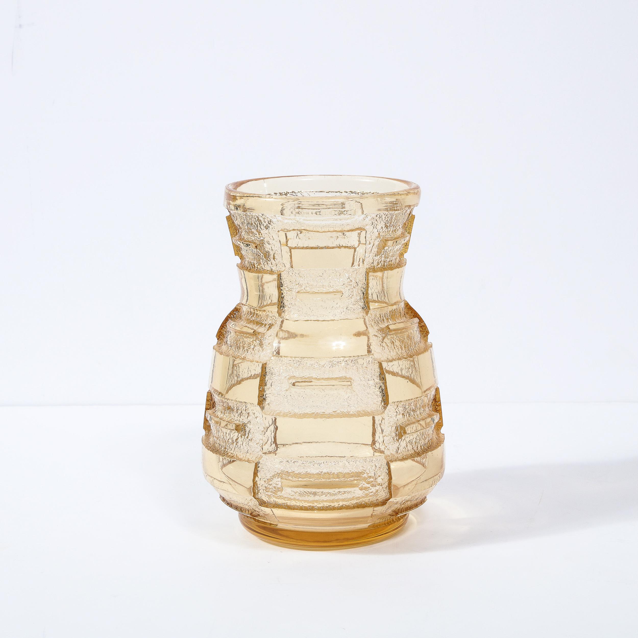 This elegant and sophisticated Art Deco vase/ vessel was realized in Nancy, France by the esteemed studio of Daum- arguably the most prestigious and highly collected atelier of the period circa 1930. The piece features a round base that dramatically