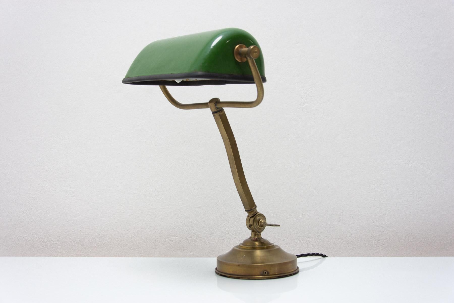 Characteristic desk lamp, Bauhaus style, designed in 1930 and made in Bohemia. The lamp has a chromium plated base and an enameled metal cap. A fantastic look that fits in many interiors.In excellent condition. New wiring.

Height: 39 cm

Width: