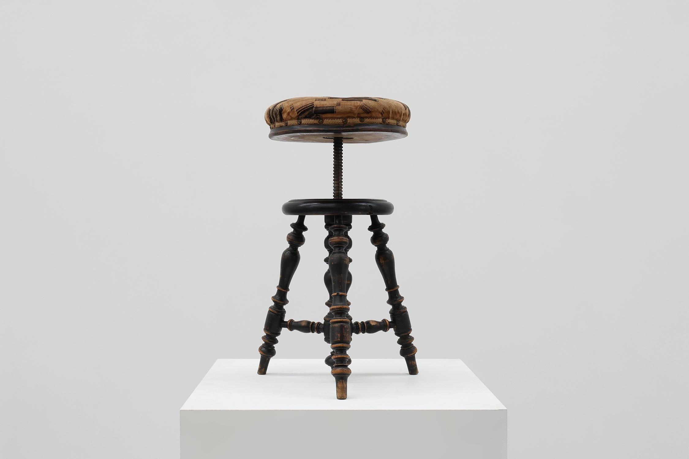 France / 1920 / piano stool / wood, metal, fabric / Art Deco

French piano stool with black lacquered turned base and original upholstery. This decorative stool rests on four turned legs with strechers. The original velvet upholstery has a geometric