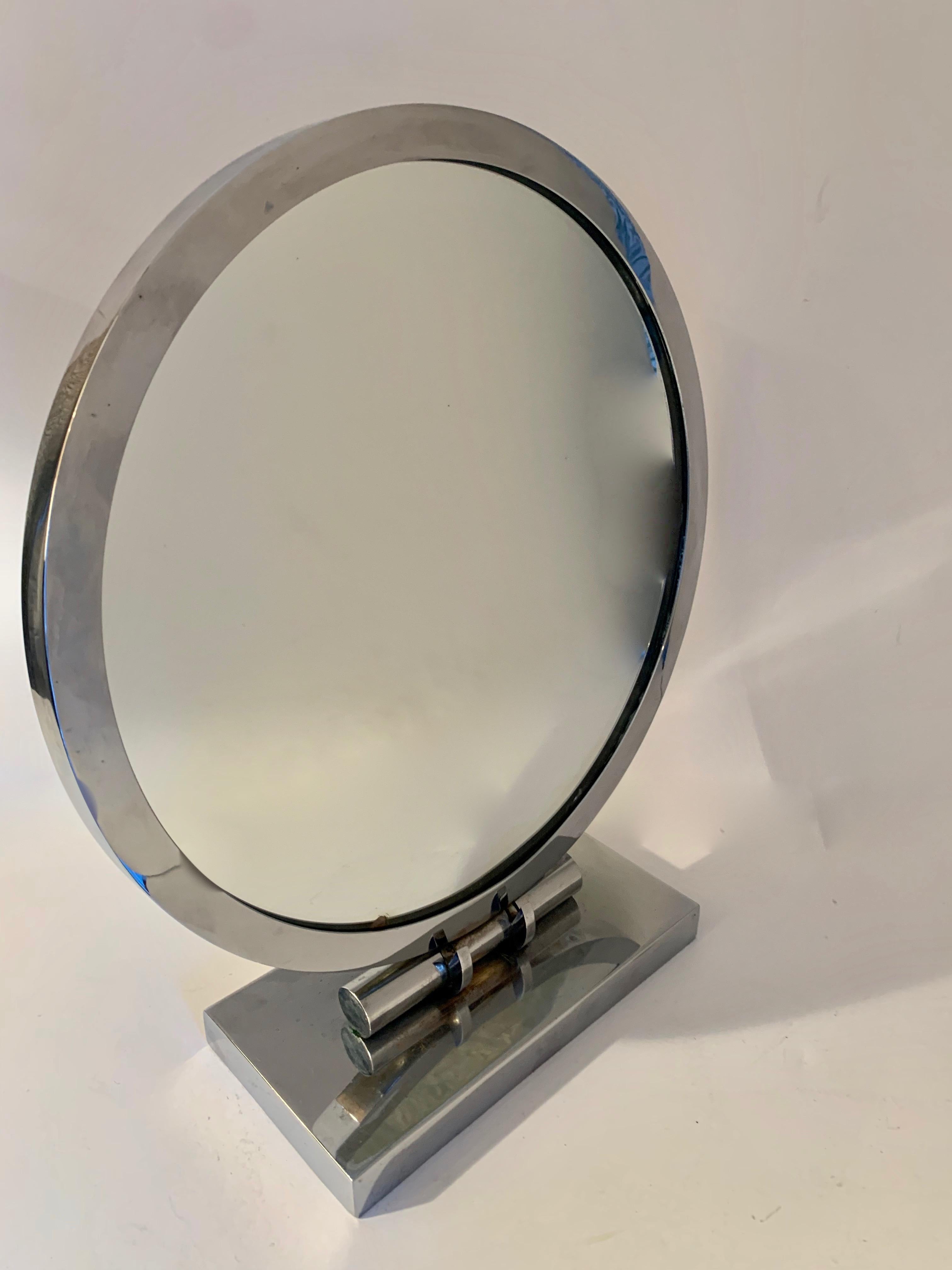Art Deco adjustable vanity mirror - chrome-plated. The Mirror is one sided and has a small blemish on the lower portion of the mirror. The base has a very nice adjustable feature which works well. The base does have some signs of age, but overall an