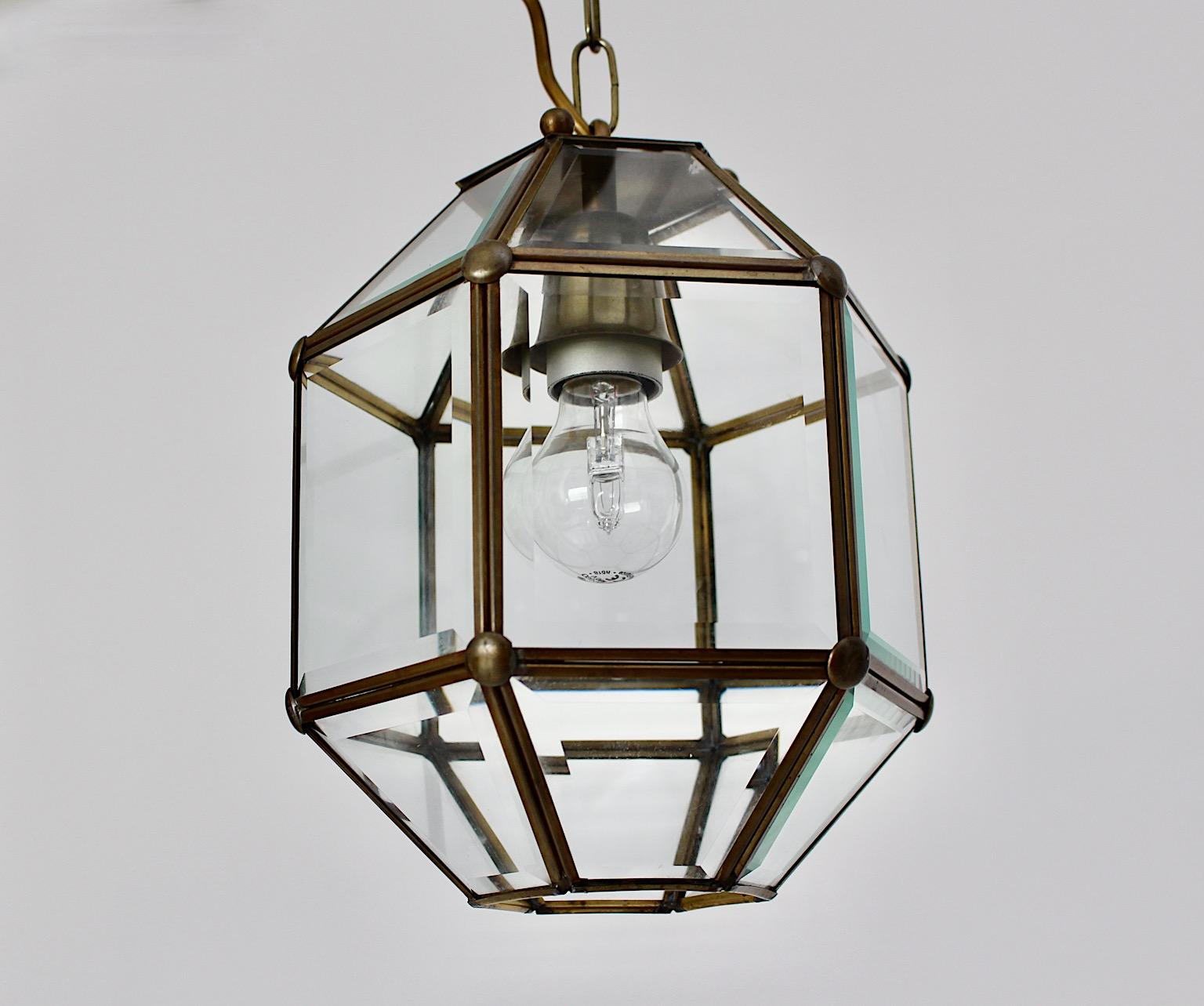 Art Deco vintage hanging lamp pendant lantern chandelier Adolf Loos style from brass and facetted clear glass 1930s Austria.
The stunning and clear cut Art Deco pendant shows eighteen facetted clear glasses in a brass frame. 
Although minimal in
