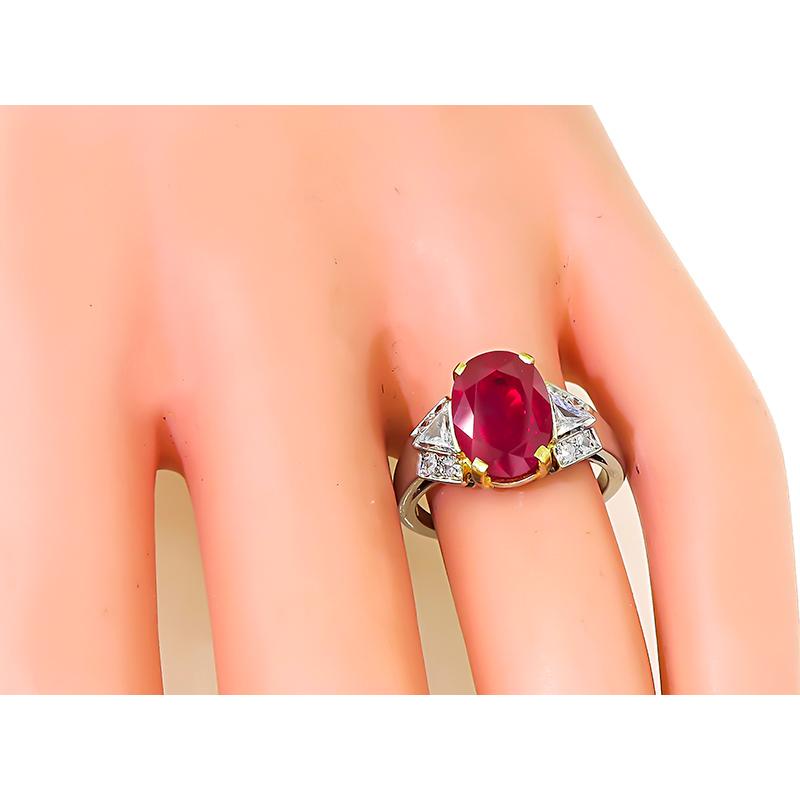 This is a stunning platinum engagement ring from the Art Deco era. The ring is centered with a lovely oval cut AGL certified natural no heat Burmese ruby that weighs 3.63ct. The ruby is accentuated by sparkling trilliant and round cut diamonds that