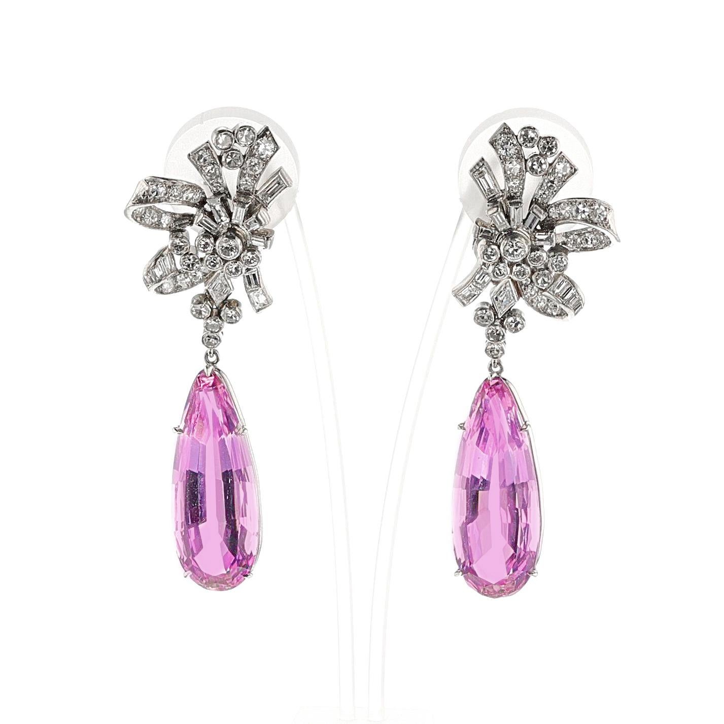 A pair of Art Deco AGL Certified Natural Pear Shape Pink Topaz and Diamond Earrings made in Platinum. The diamonds are single cut. The Natural Pink Topaz pair weighs 14.56 carats and 13.03 carats. The Diamond weight is appx. 5.50 carats. Earrings