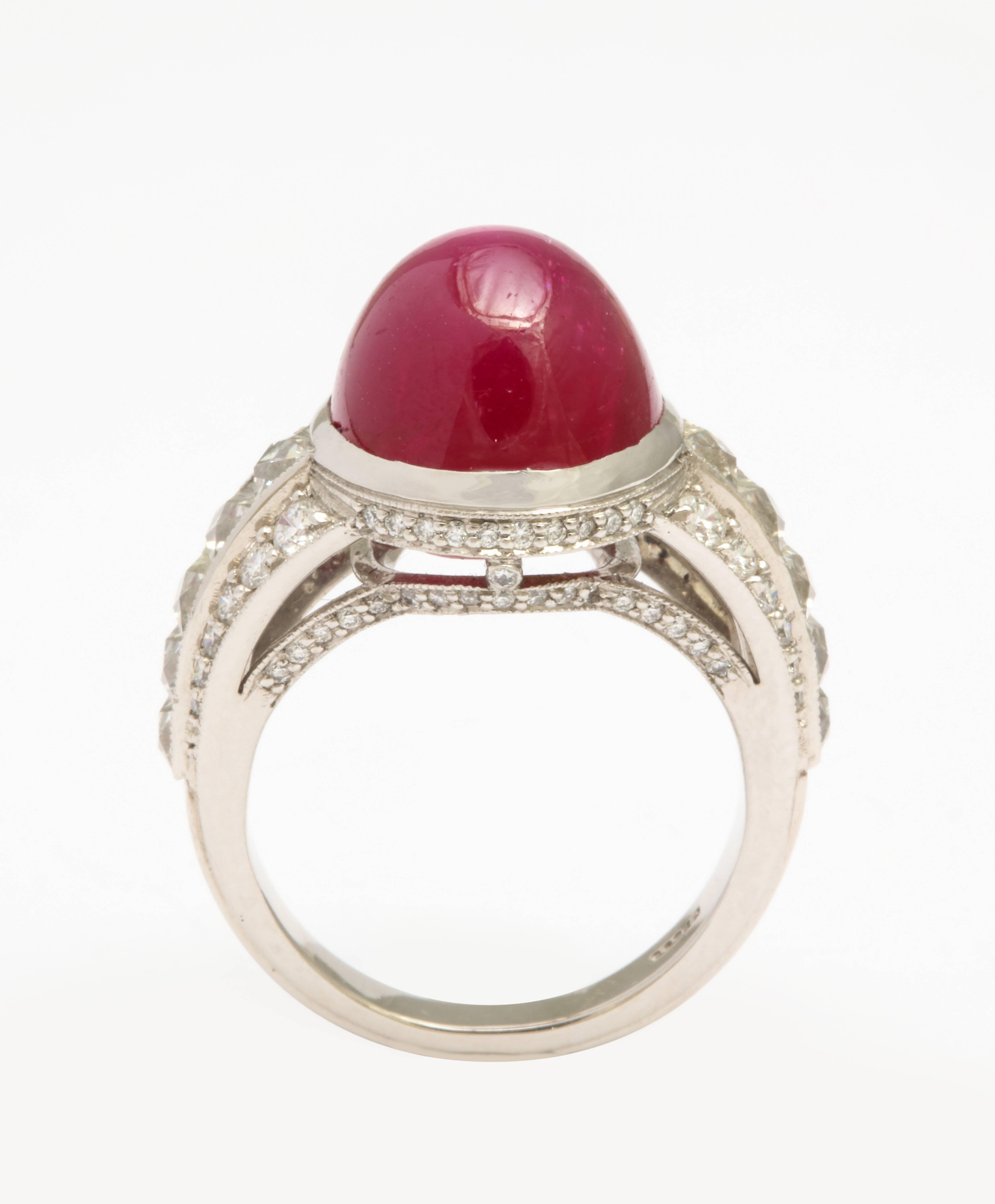 A beautiful 14.68 carat cabochon Burma no heat ruby set in an expertly crafted ring with French cut diamonds and round brilliant cut diamonds. The ruby is accompanied by an AGL certificate. The diamonds have an estimated weight of 1.64 carats. Set