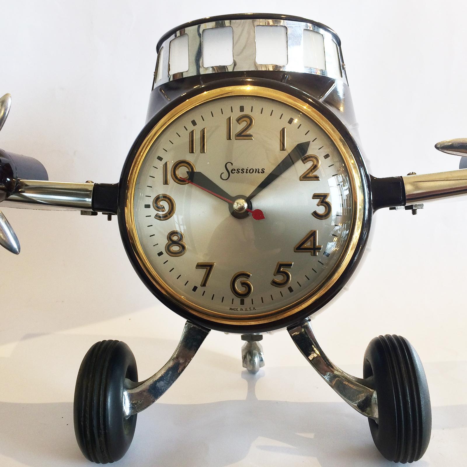 Art Deco clock by “Sessions, U.S.A.”, in Bakelite, chrome and aluminium, in form of an aeroplane with wings, front cabin and wheels only (no fuselage or rear body). A truly great piece of fun for the aeroplane or clock enthusiasts. Cast aluminium