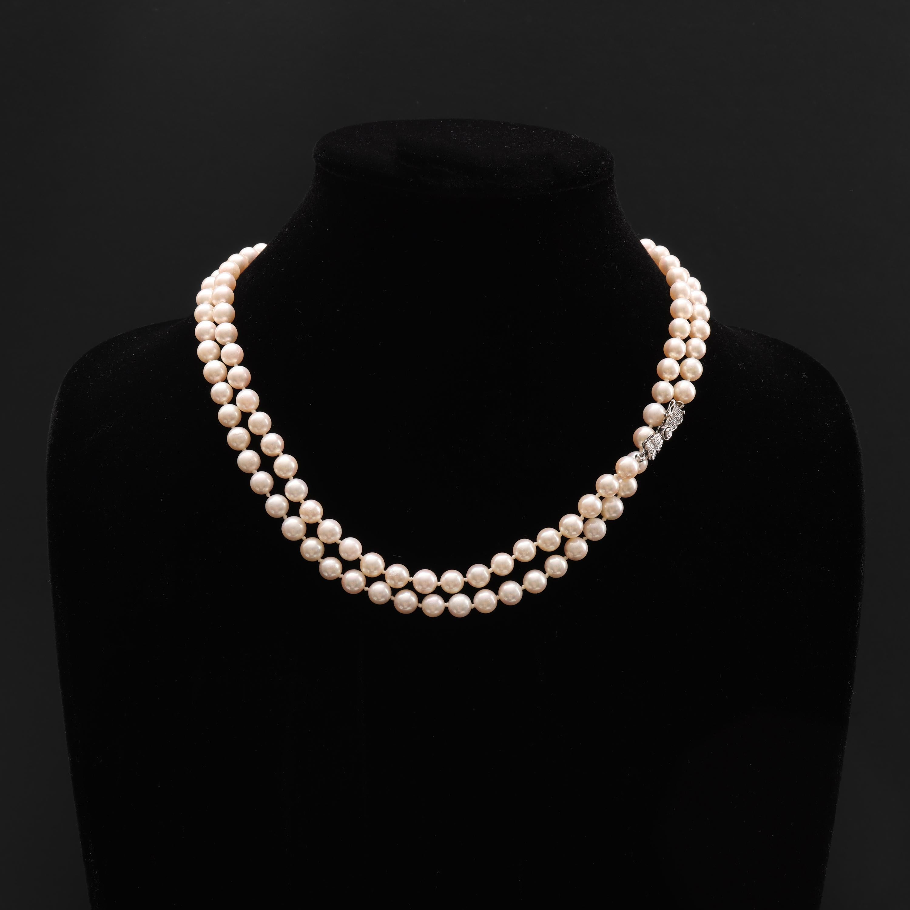 121 gleaming and luminous cultured Akoya pearls form this magnificent Art Deco-era necklace. The opera-length -37 inch- necklace is completed by a 14k white gold bow clasp set with old-cut diamonds.  The pearls range in size from 6mm to nearly 7mm