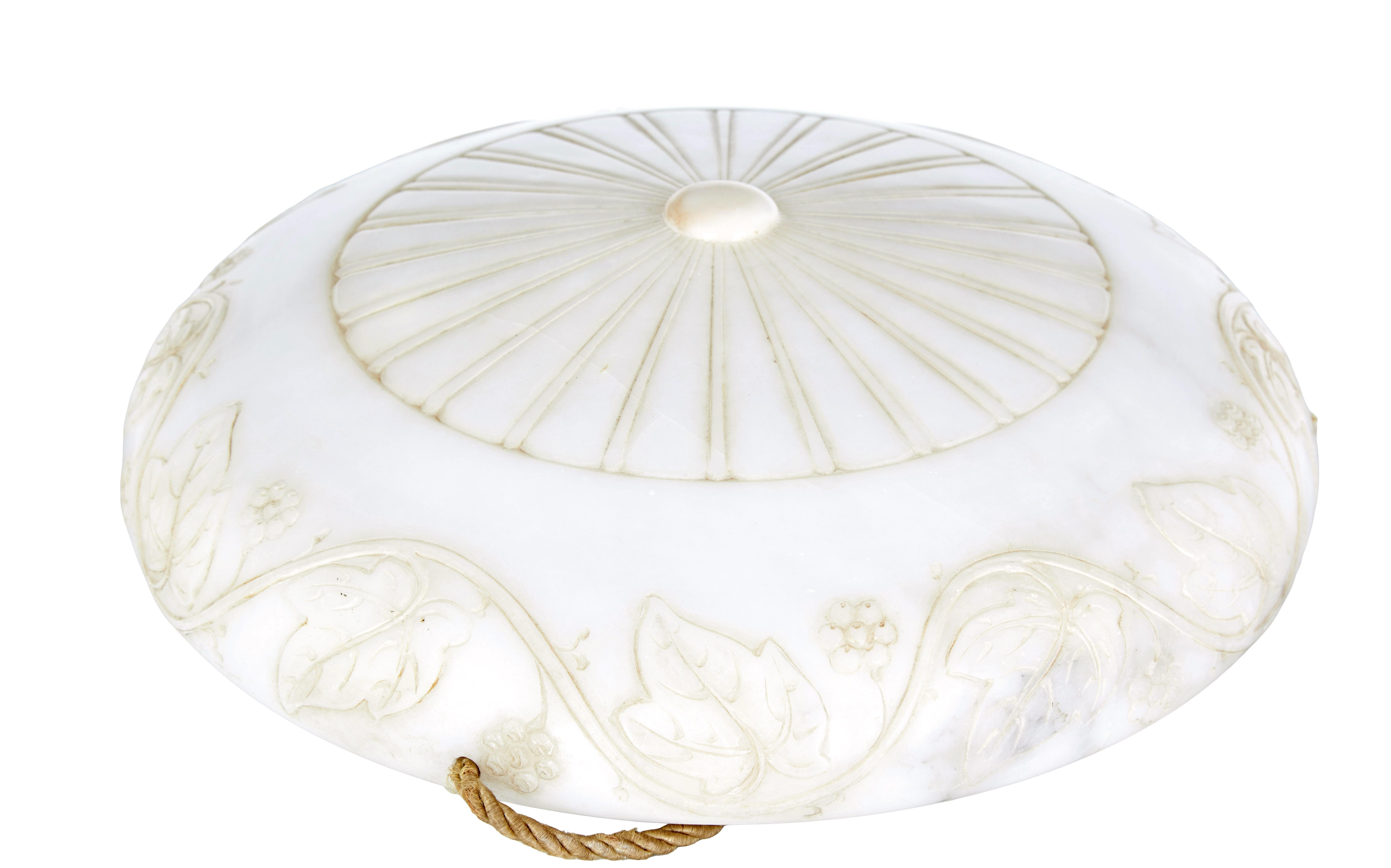 Art deco alabaster and brass pendant light circa 1930.

Beautiful quality carved alabaster hanging ceiling dish light.

Circular bowl with carved round fan to the centre of the base, and flowing carved acanthus leaves around the rim.  Suspended by 3