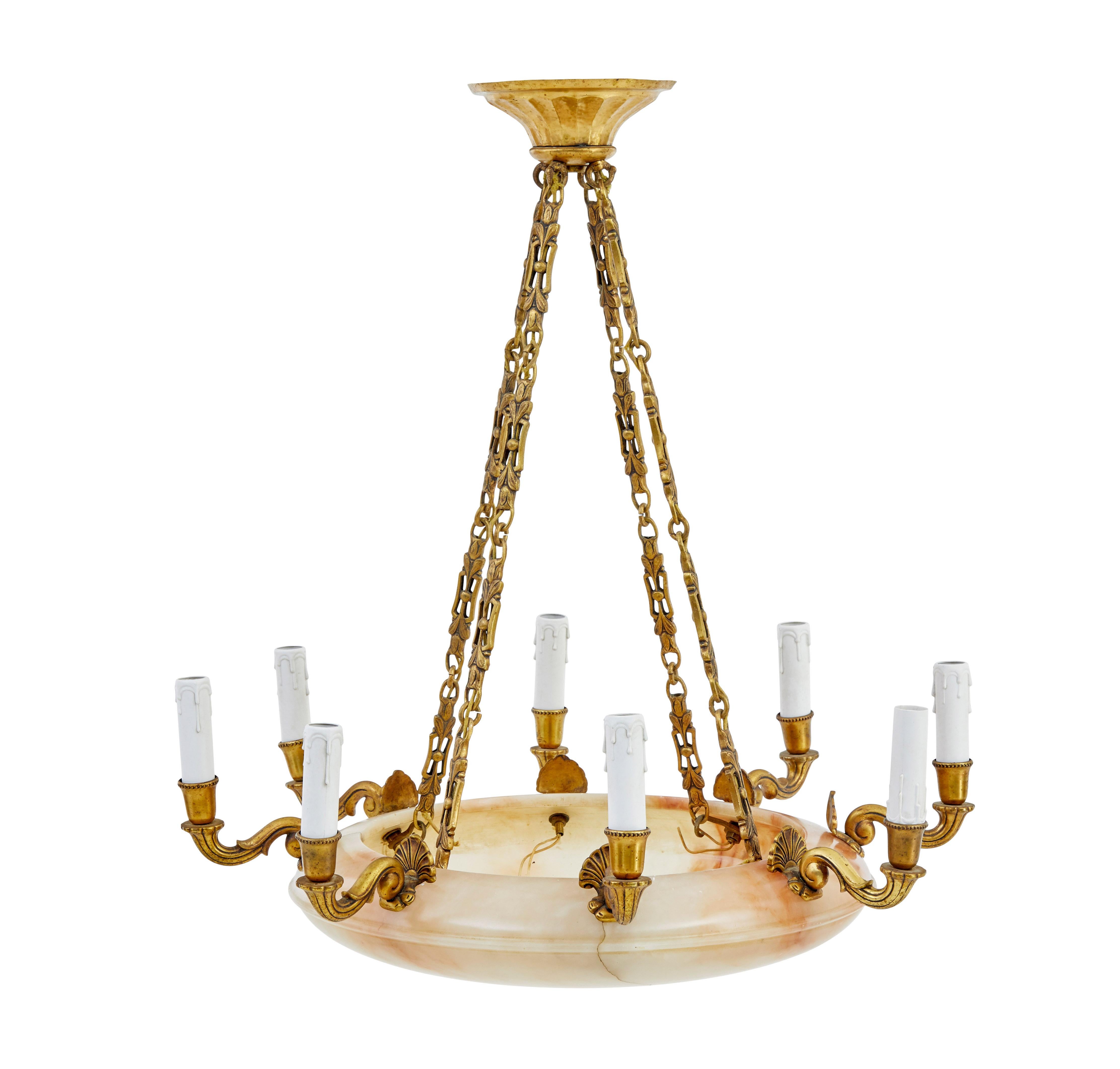 Fine quality art deco period art deco alabaster ceiling light circa 1920.

8 arm chandelier with light fitments and faux candle covers. 4 bulb holders inside the bowl to illuminate the stone. Suspended by 4 heavy decorative chains leading up to the
