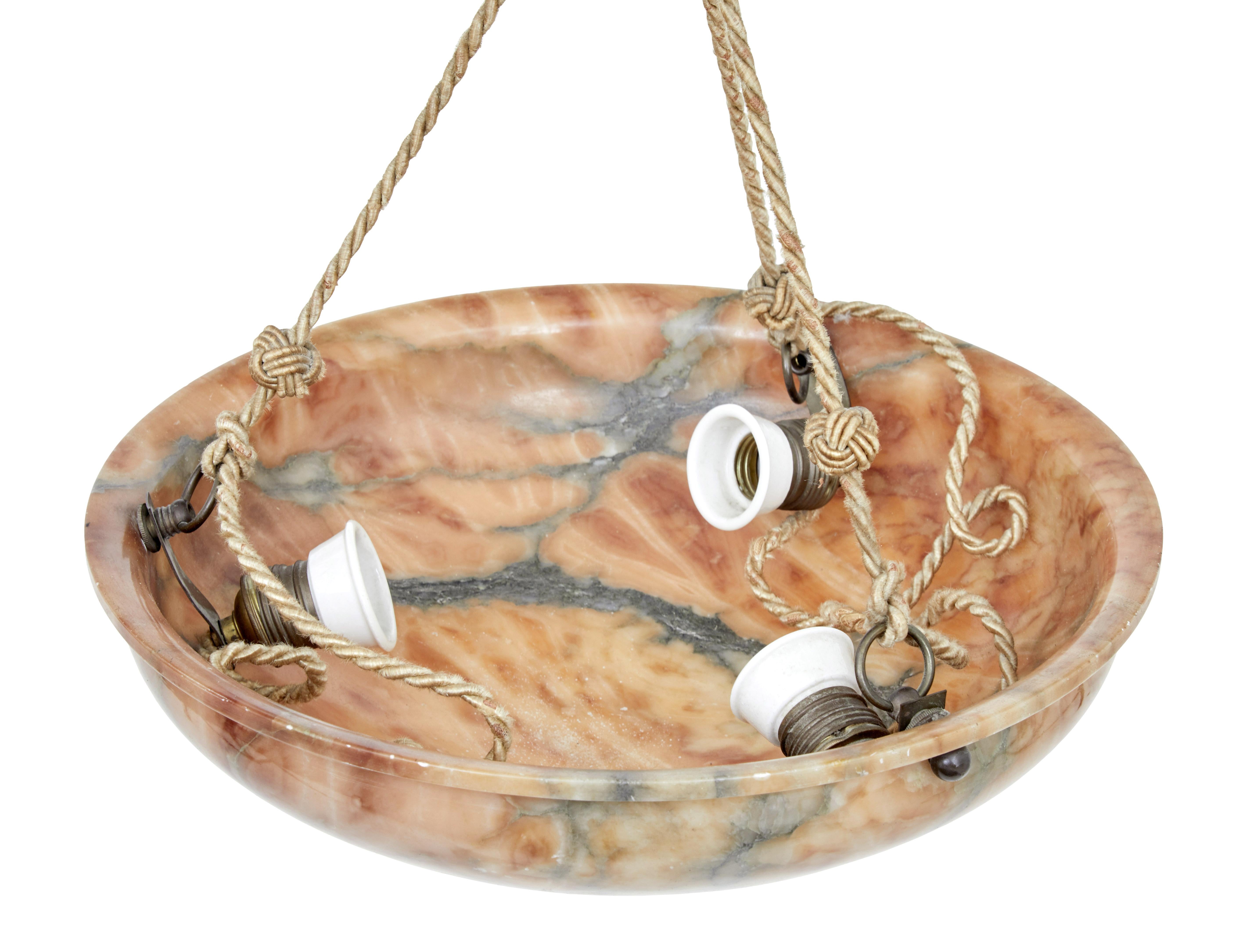 Art Deco alabaster dish ceiling light, circa 1920.

Art Deco period ceiling light made from carved alabaster. Ceiling rose of the same stone, with a 16 inch diameter bowl suspended by 3 ropes. Fitted with 3 bulb holders.

Minor surface marks. We