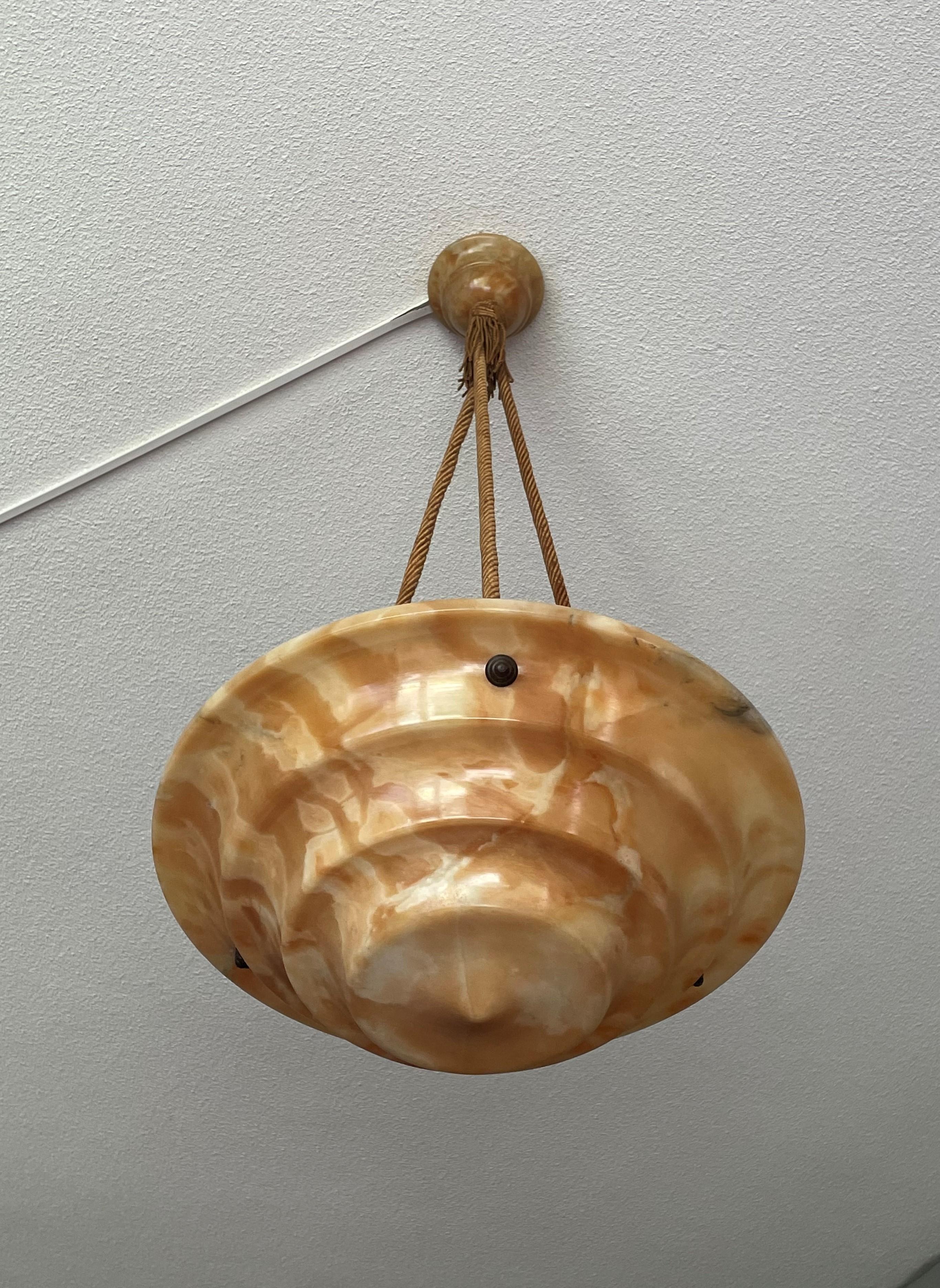 Stunning, amber color alabaster chandelier with unique stripe patterns.

This practical size and superb condition Art Deco pendant could not be more original. Apart from the wiring, every piece, from the alabaster canopy down to the remarkable Art