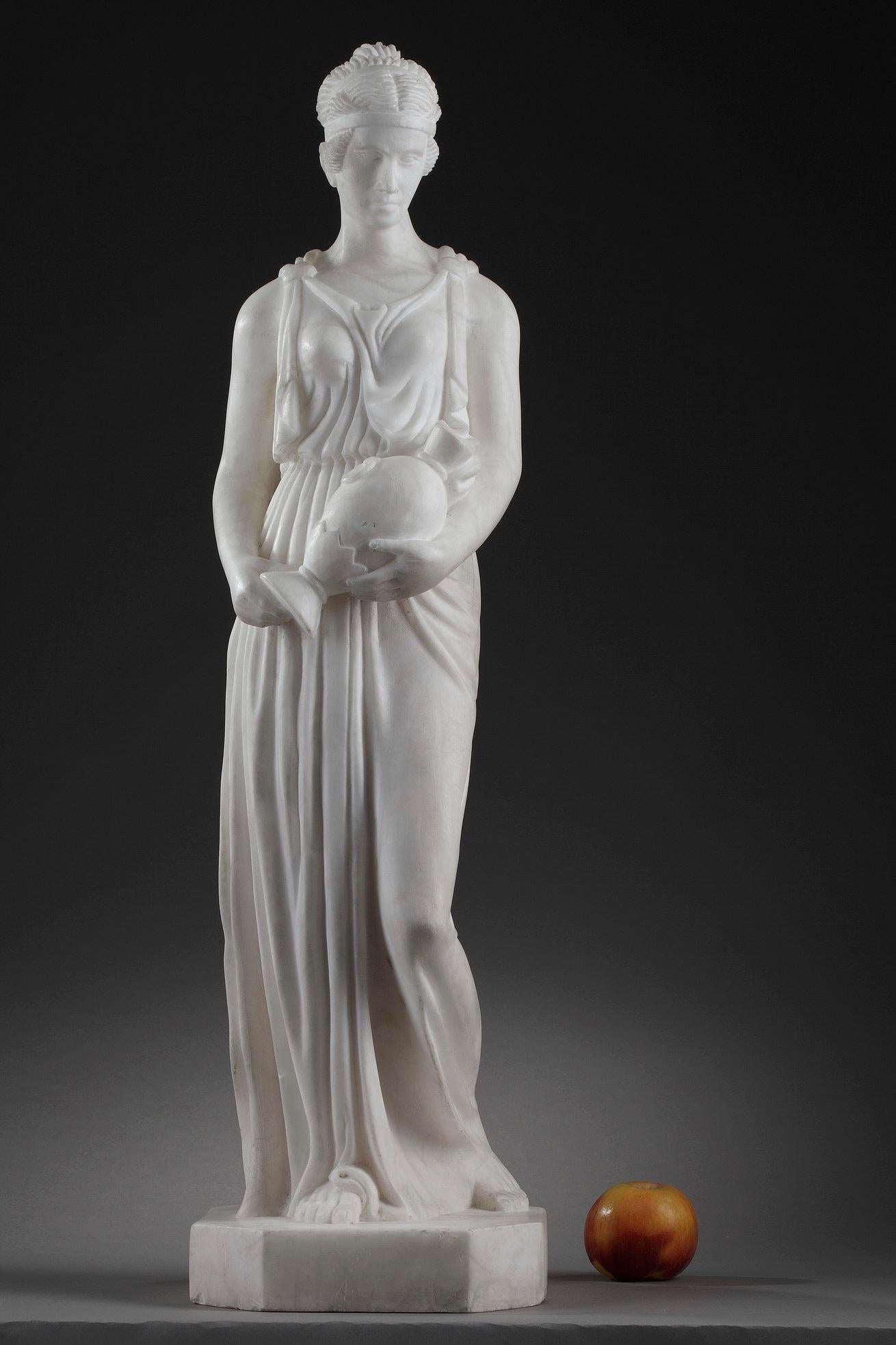 This Art Deco sculpture captures the Samaritan woman wearing a tunic draped about her body, carrying the jug. Her hair pulled up in a bun, is supported by a diadem. Carved from alabaster, the statue is a beautiful example of Classical style. The