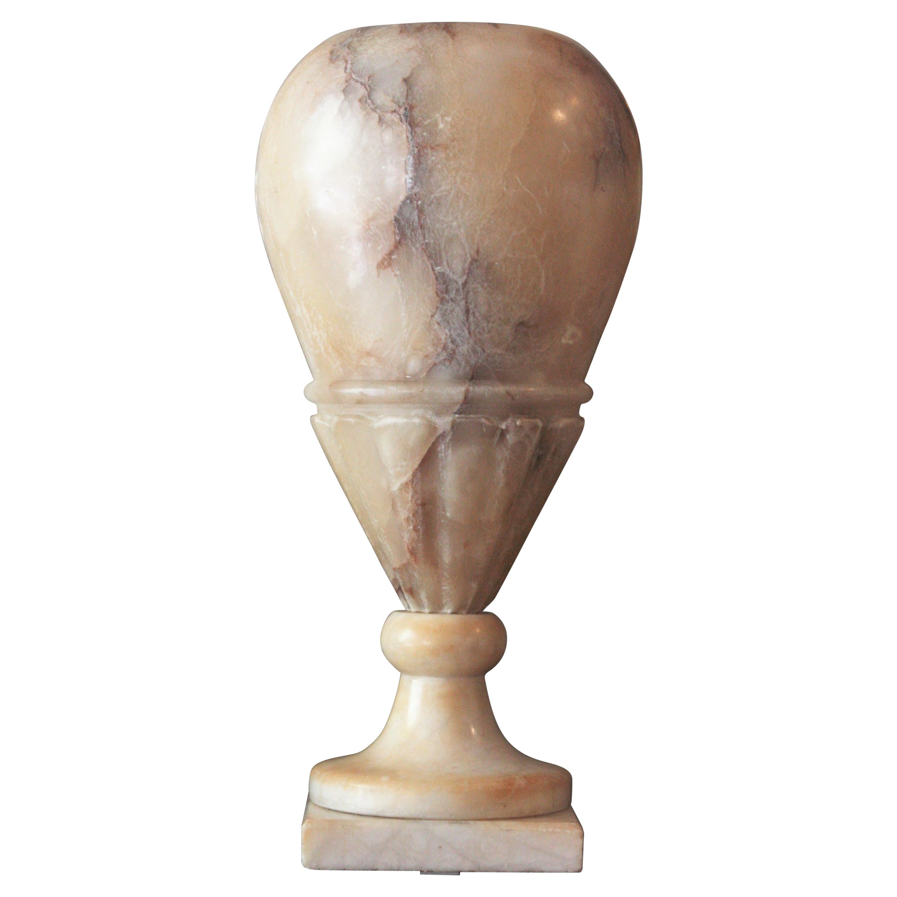 Stylish Art Deco alabaster urn shaped uplighter table lamp with carved bottom, Spain, 1930s.
Elegant and classical design, highly decorative effect when lit and nice patina.
Terrific aged patina with dark veins.
Place it alone or as a part of a