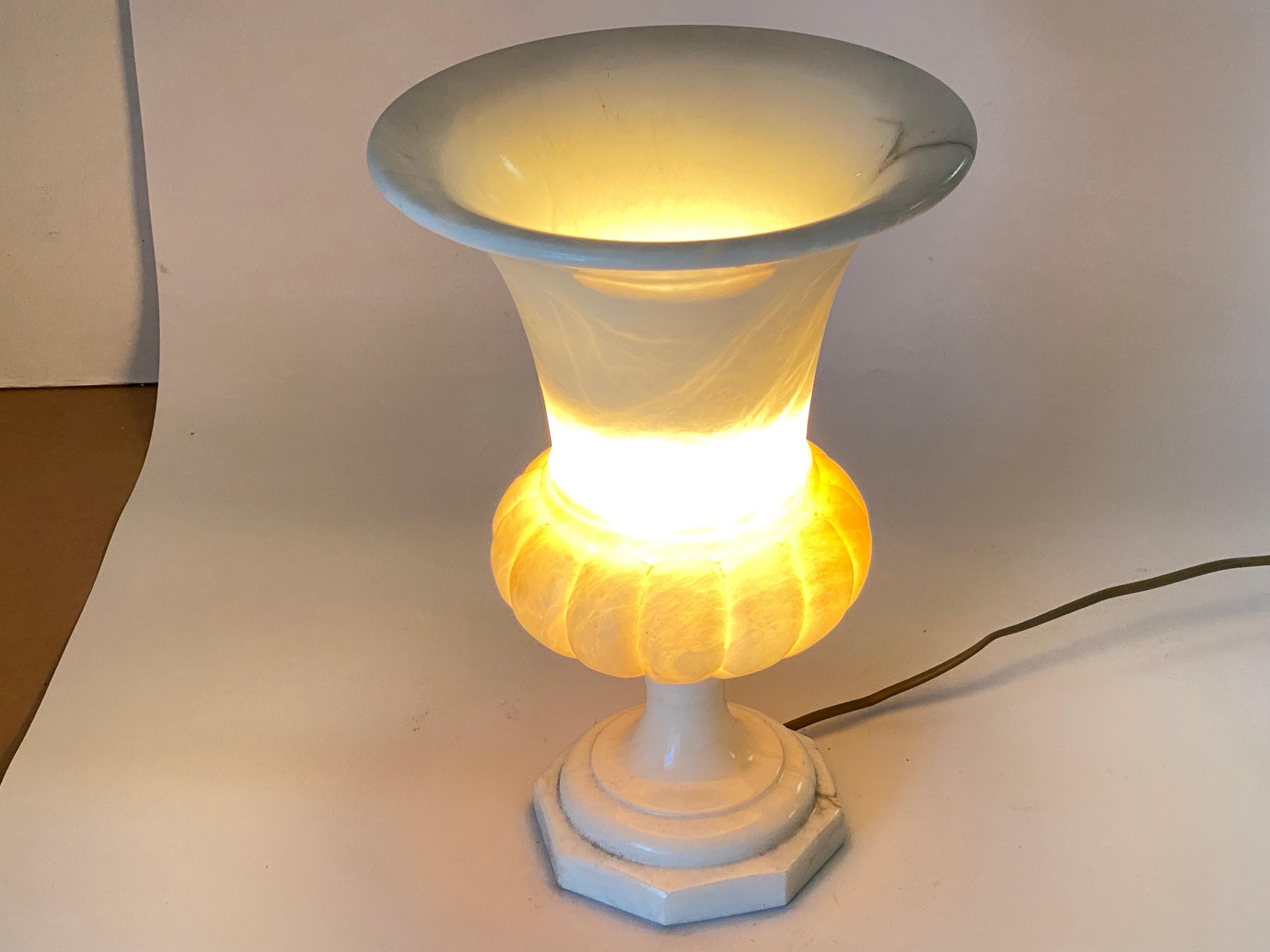 Sculptural alabaster Art Deco period urn table lamp with neoclassical design, France, 1940s.
This elegant carved alabaster neoclassical 'uplighter' urn lamp will be a nice addition placed in a console table or side table.
It provides a charming