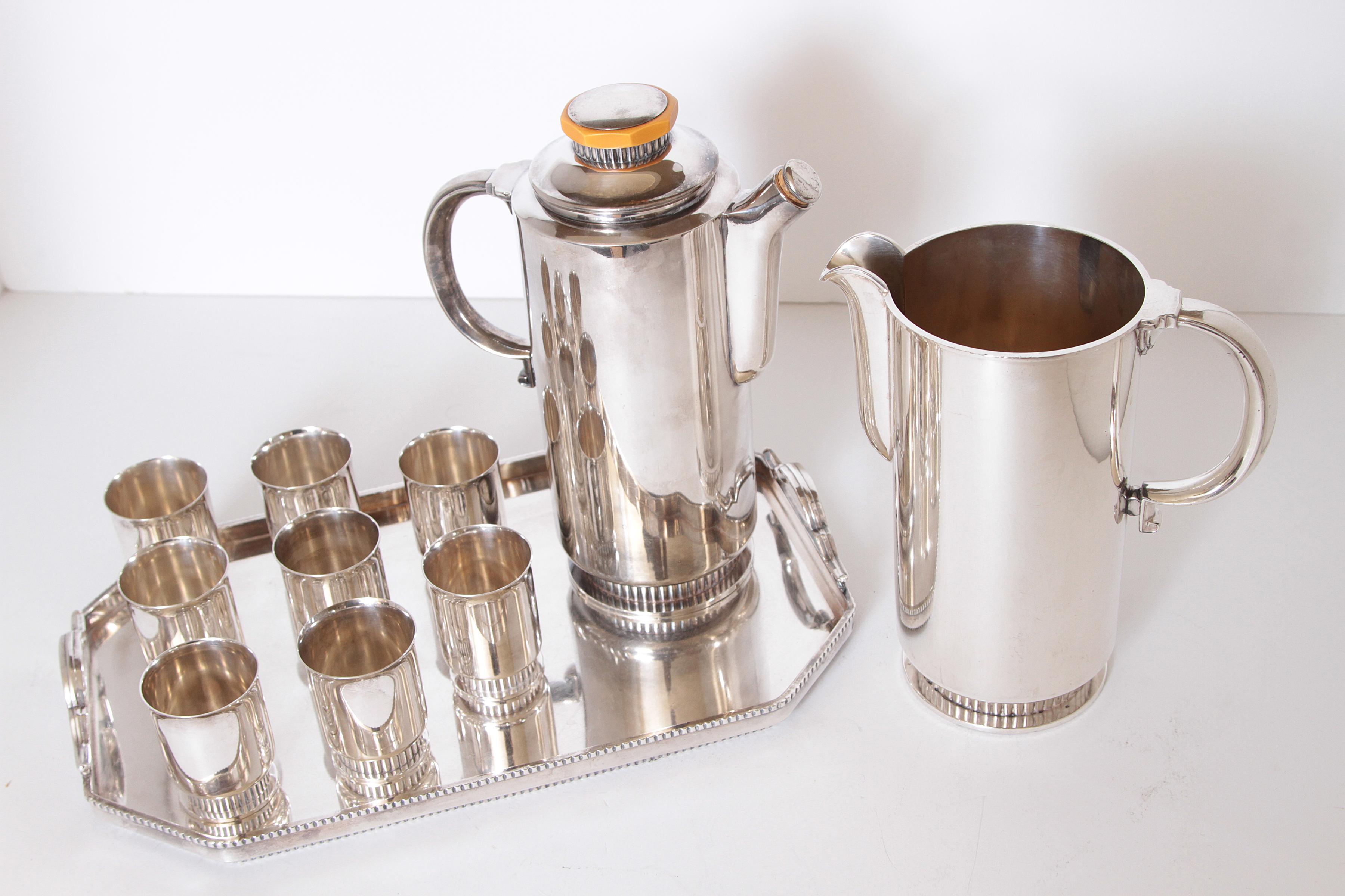 Early Art Deco Albert Feinauer silver plate / Catalin cocktail set for Barbour Silver, circa 1930

Likely heretofore unseen set of 11 matched Feinauer bar items. 
Cocktail serving set: Cordials, Shaker, Mixing pitcher, Tray.
Extremely rare and