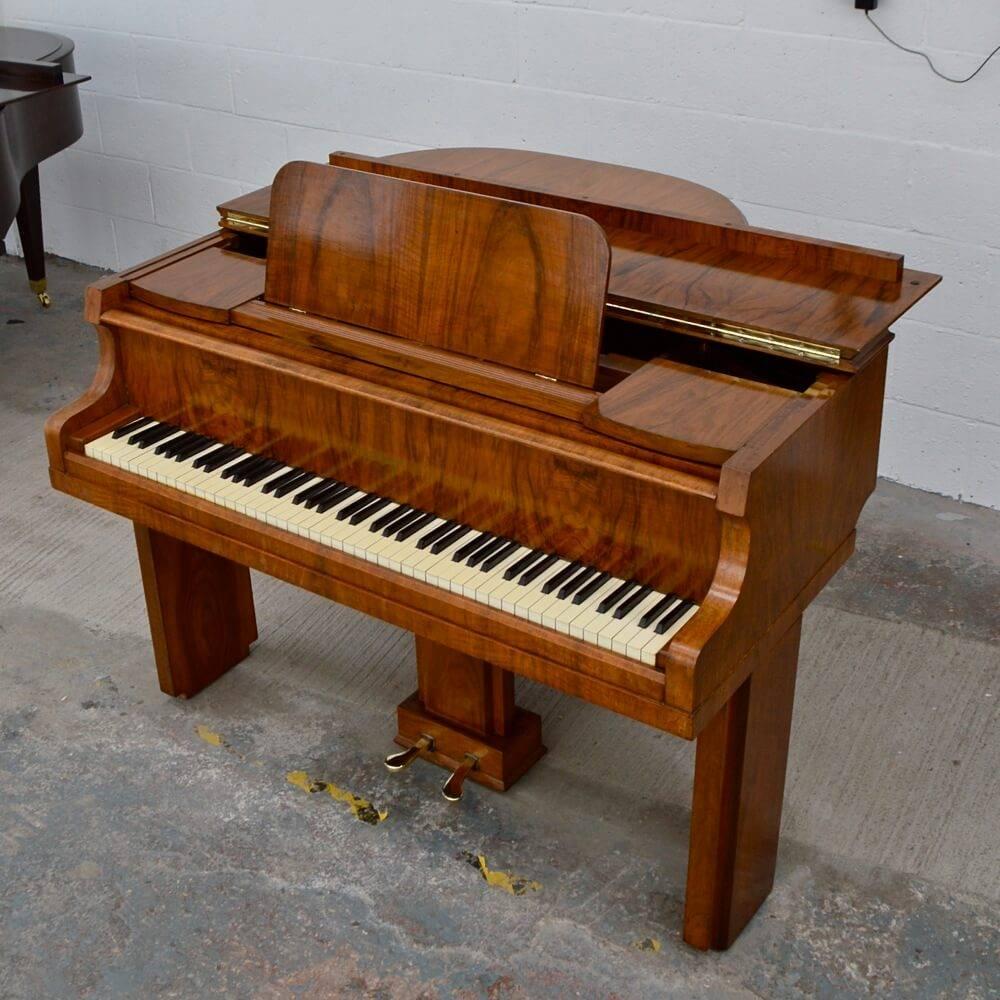This is a rare Art Deco period Allison baby grand piano in walnut finish. Allison of London Pianos were one of England's finest piano makers. They only produced pianos of the highest quality - these pianos were built by the finest of artisans using