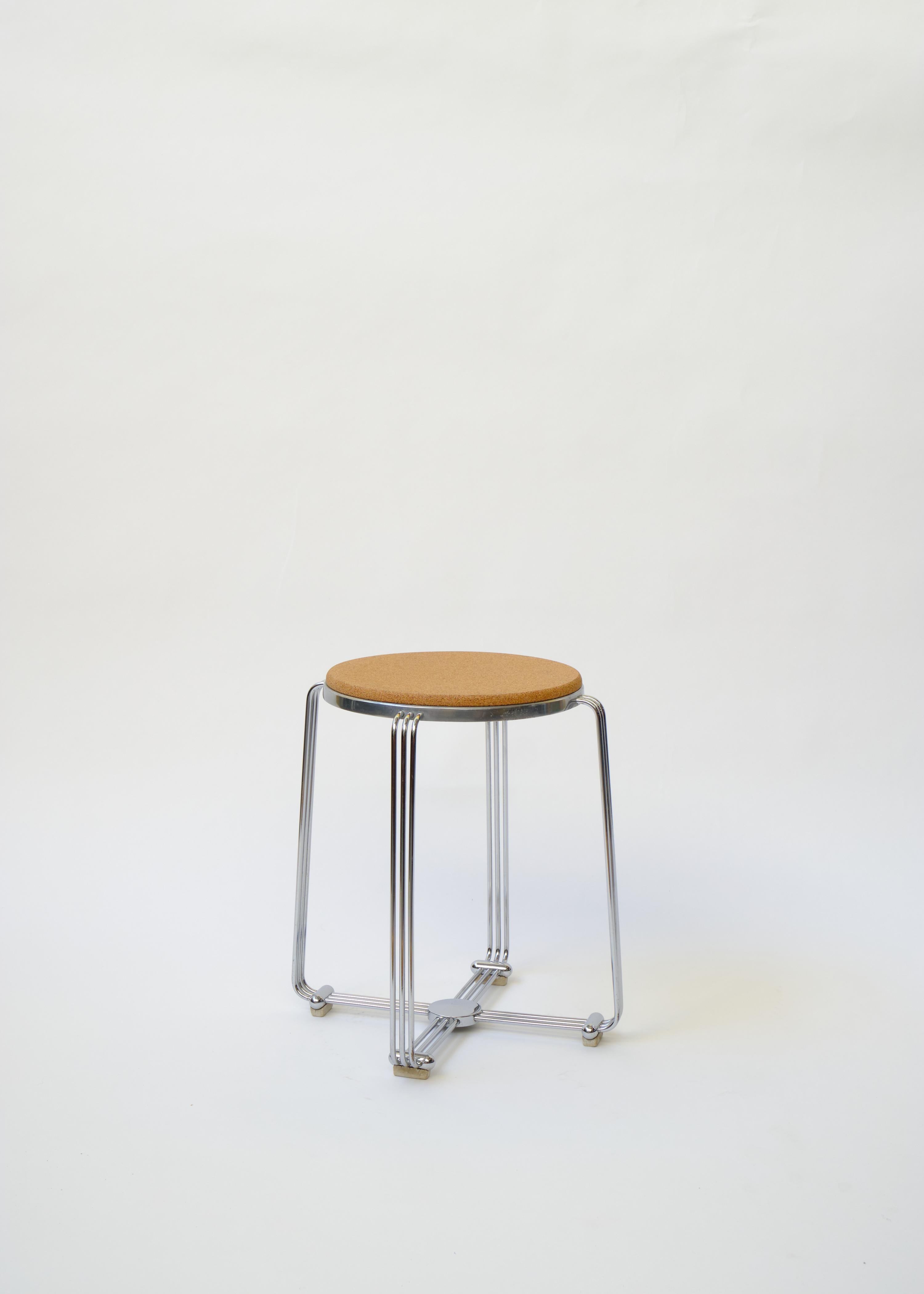 Cast aluminium base supported by four continuous splaying tubular chromed legs joined at the base by a central boss. Rubber feet are all original. The cork seats were long perished and have recently been replaced with new bevelled edge cork seats,