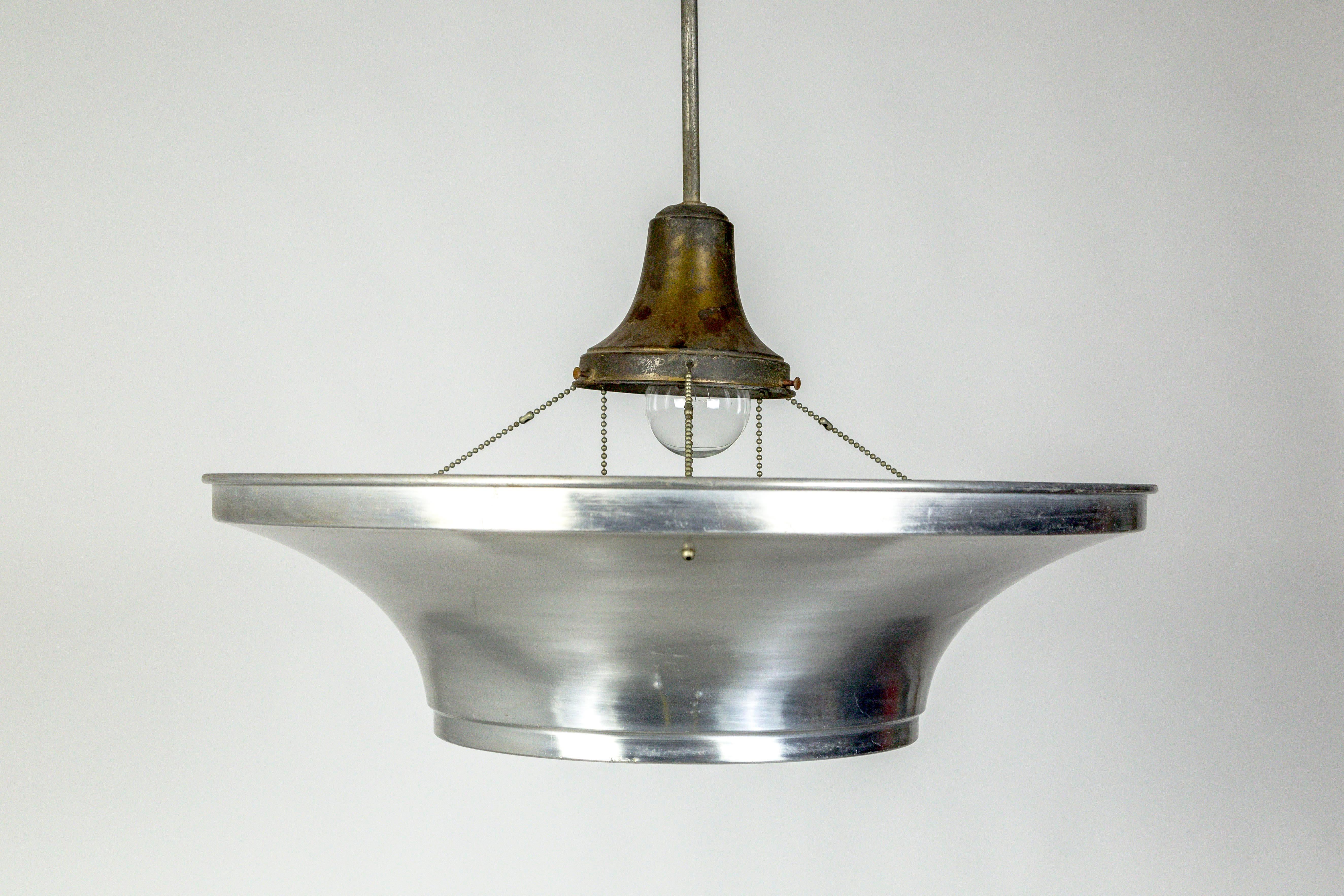 Art Deco pendant lights with an Industrial look; aluminum dishes hanging from delicate ball chain, holding thick, radial ribbed glass diffusers. With a long, slim stem, 63
