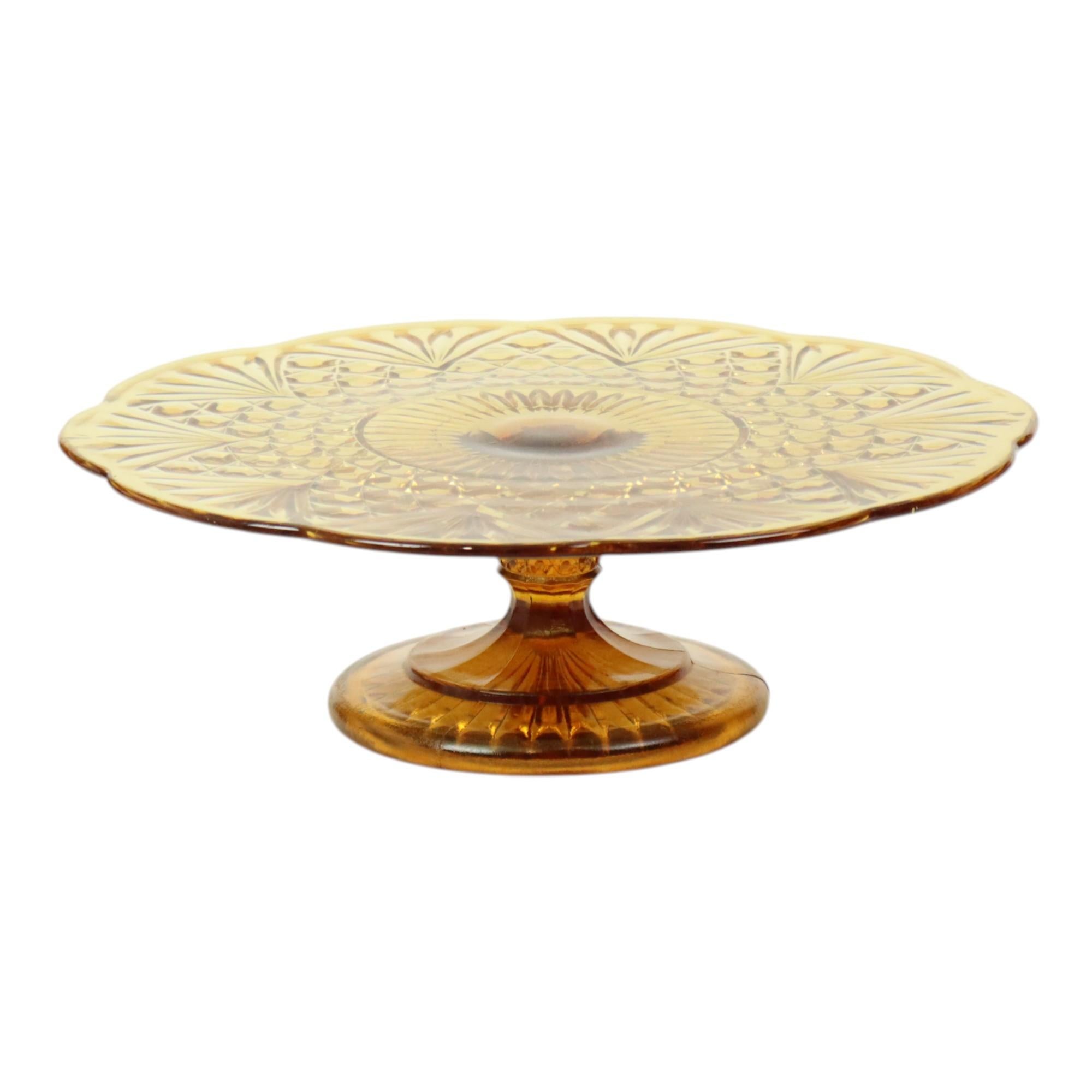 Beautiful, large vintage amber-colored cake stand with a floral and diamond pattern, featuring an elegant wavy edge along the outside. Made of pressed colored glass, also known as Depression glass, from the Art Deco period, and marked 