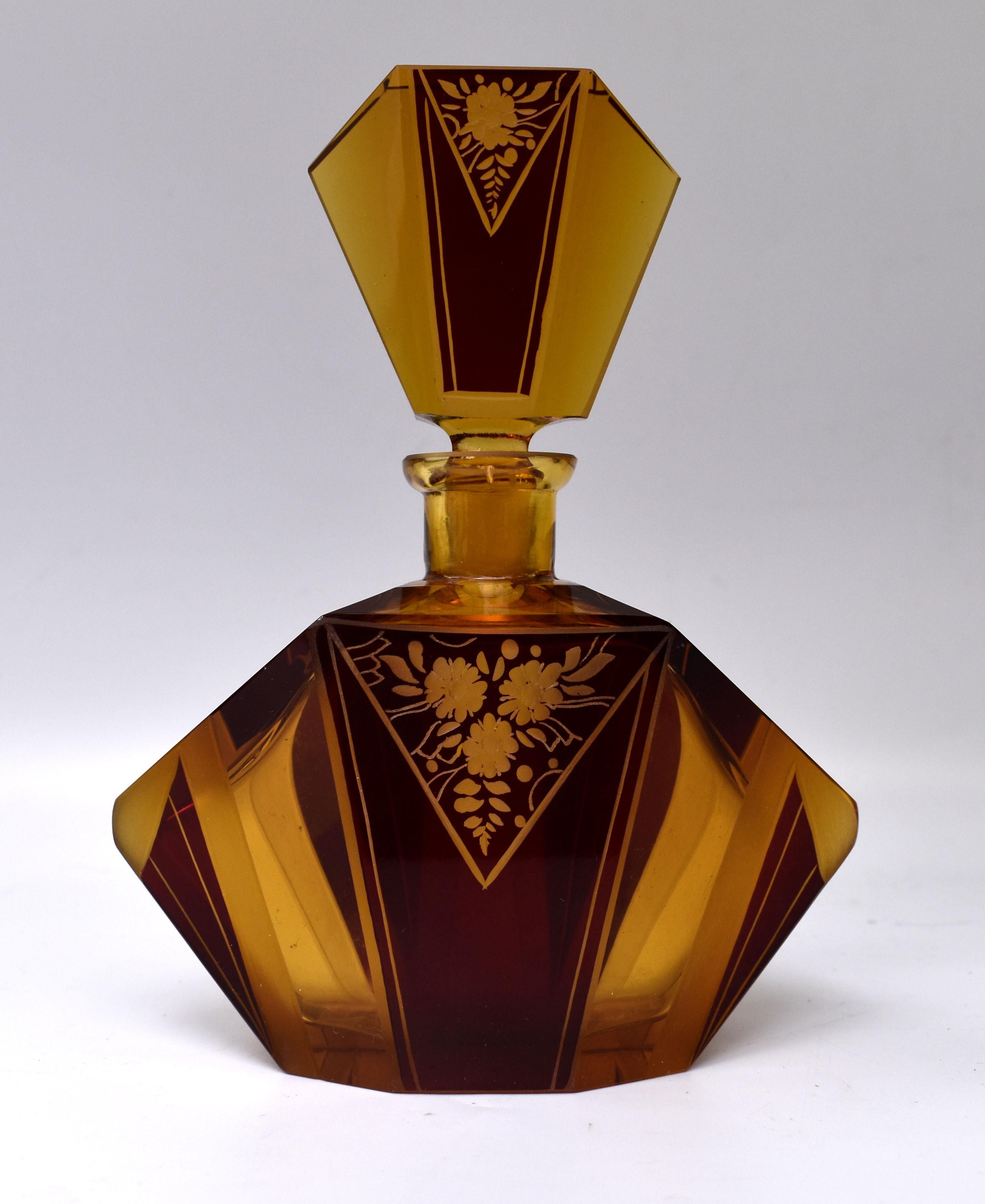 A truly beautiful Art Deco amber glass scent bottle with a very attractive and iconic shape and patterning with geometric dark red enamel decoration to both the body of the bottle and stopper. Manufactured in Czech republic in the 1930s this