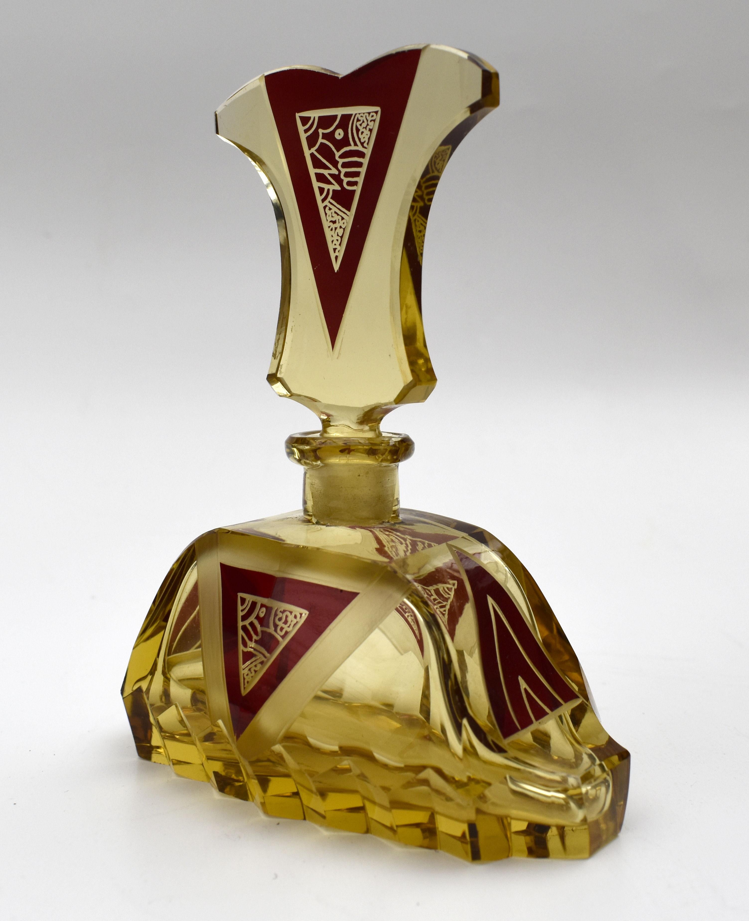 A truly beautiful Art Deco amber glass scent bottle with a very attractive and iconic shape and patterning with geometric dark red enamel decoration to both the body of the bottle and stopper. Manufactured in Czech republic in the 1930s this