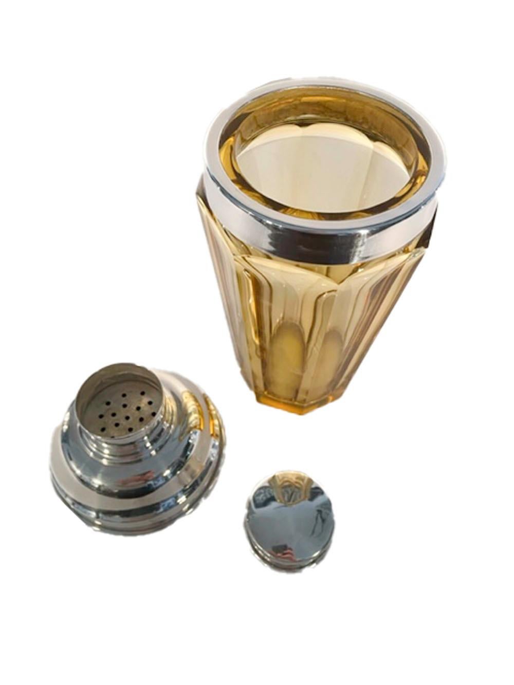 Art Deco cocktail shaker of amber colored glass with 8 polished sides and topped with a silver-plated, center-pour cover.