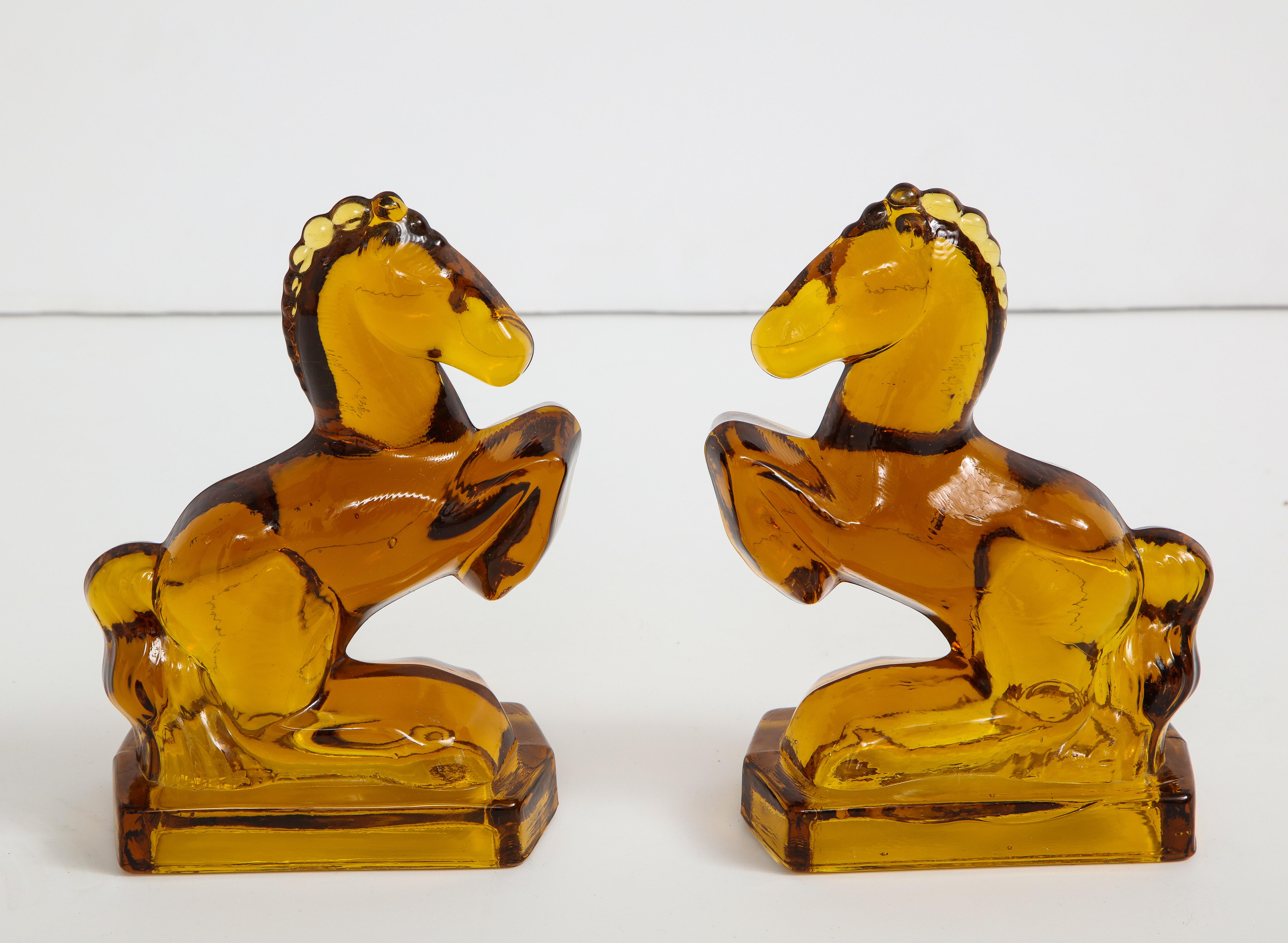 Set of Art Deco amber glass stylized prancing horse bookends, circa 1930s.