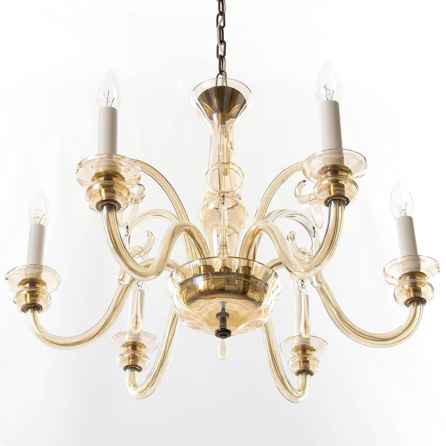 A beautiful six-arm Art Deco chandelier made of brass and handblown amber tone Murano glass. 
It is in very good condition and ready to use.
Measures: Height of body without chain: 17.7 inch (45 cm).
Overall drop can be customized for free of