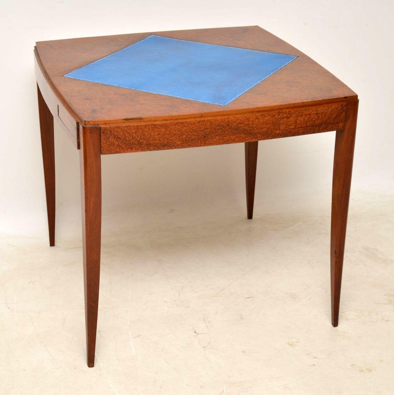 Very stylish Art Deco card table with a tooled leather playing surface and pull out compartments, which are possibly meant for money or chips. The wood used is very exotic and I believe it’s Amboyna. It’s a very unusual model and not one I’ve seen