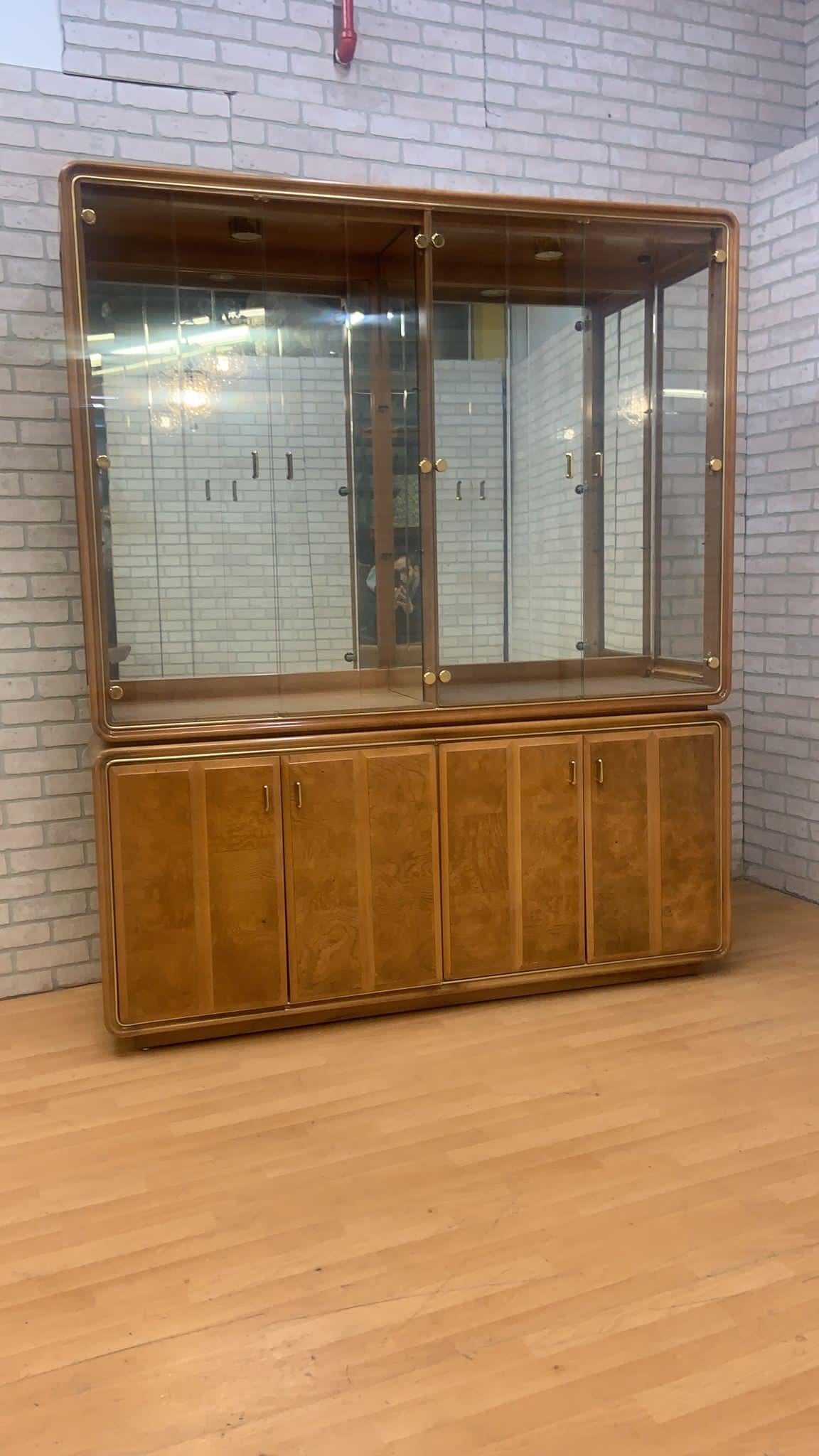 Art Deco American of Martinsville burlwood mirror China cabinet

Stunning Art Deco American of Martinsville mirrored olive wood burl china cabinet from American of Martinsville. Upper section features four glass doors with floating brass hardware,