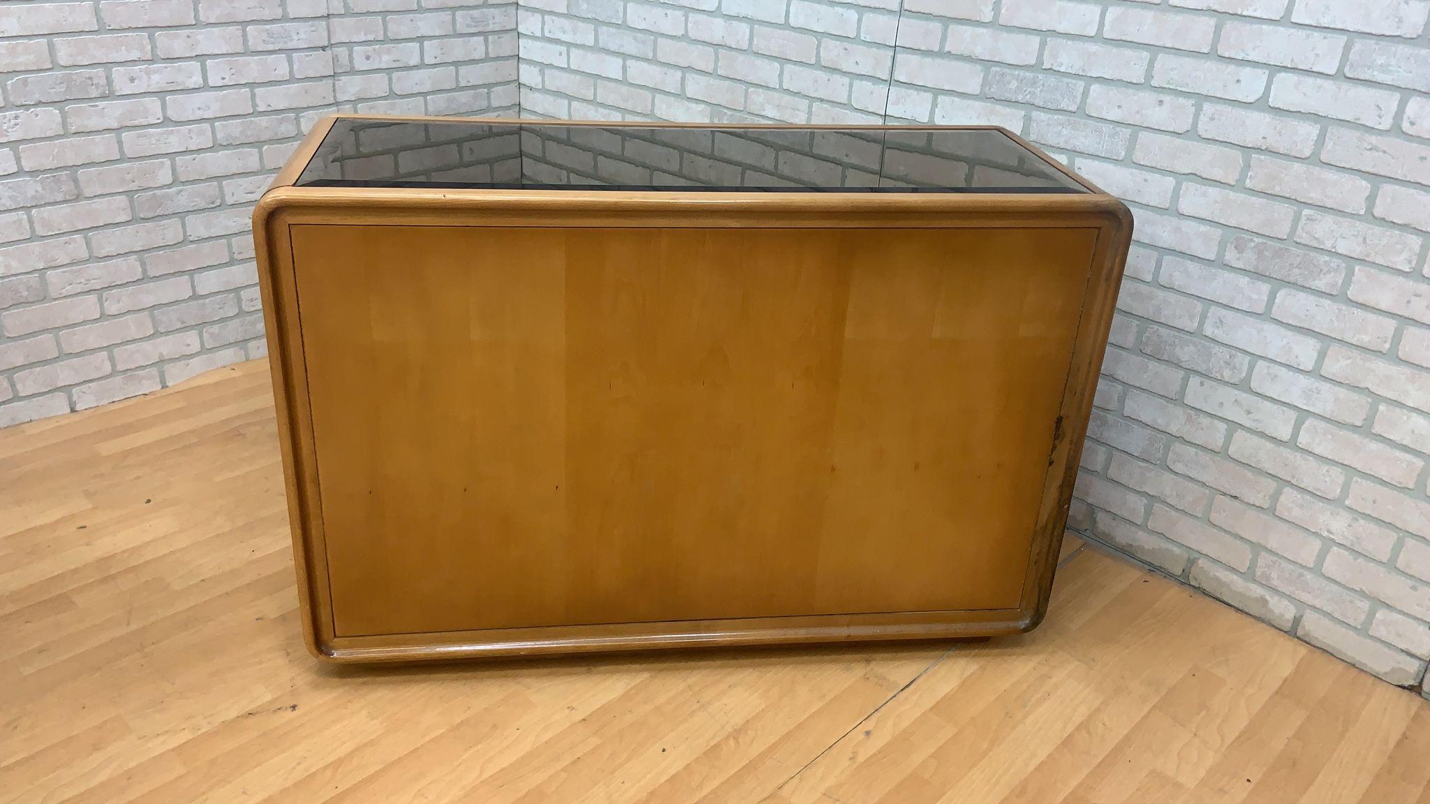 Art Deco American of Martinsville Burlwood serving cabinet

Mirrored top olive wood burl bar serving cabinet from American of Martinsville. It has 2 side cabinets with beautiful burl doors and shelving. The middle cabinet has a mirrored back and