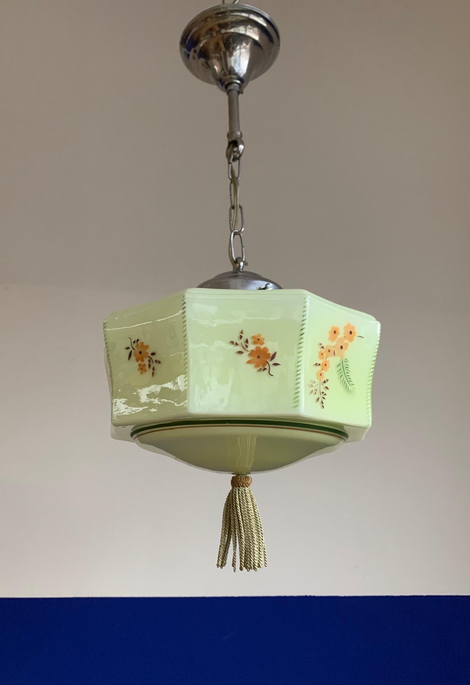 Handcrafted and rare lantern-like pendant.

This rare combination-of-styles, Anglo American pendant is in excellent condition and a joy to own and look at. The mouthblown glass shade is of an amazing geometrical Art Deco design and the template