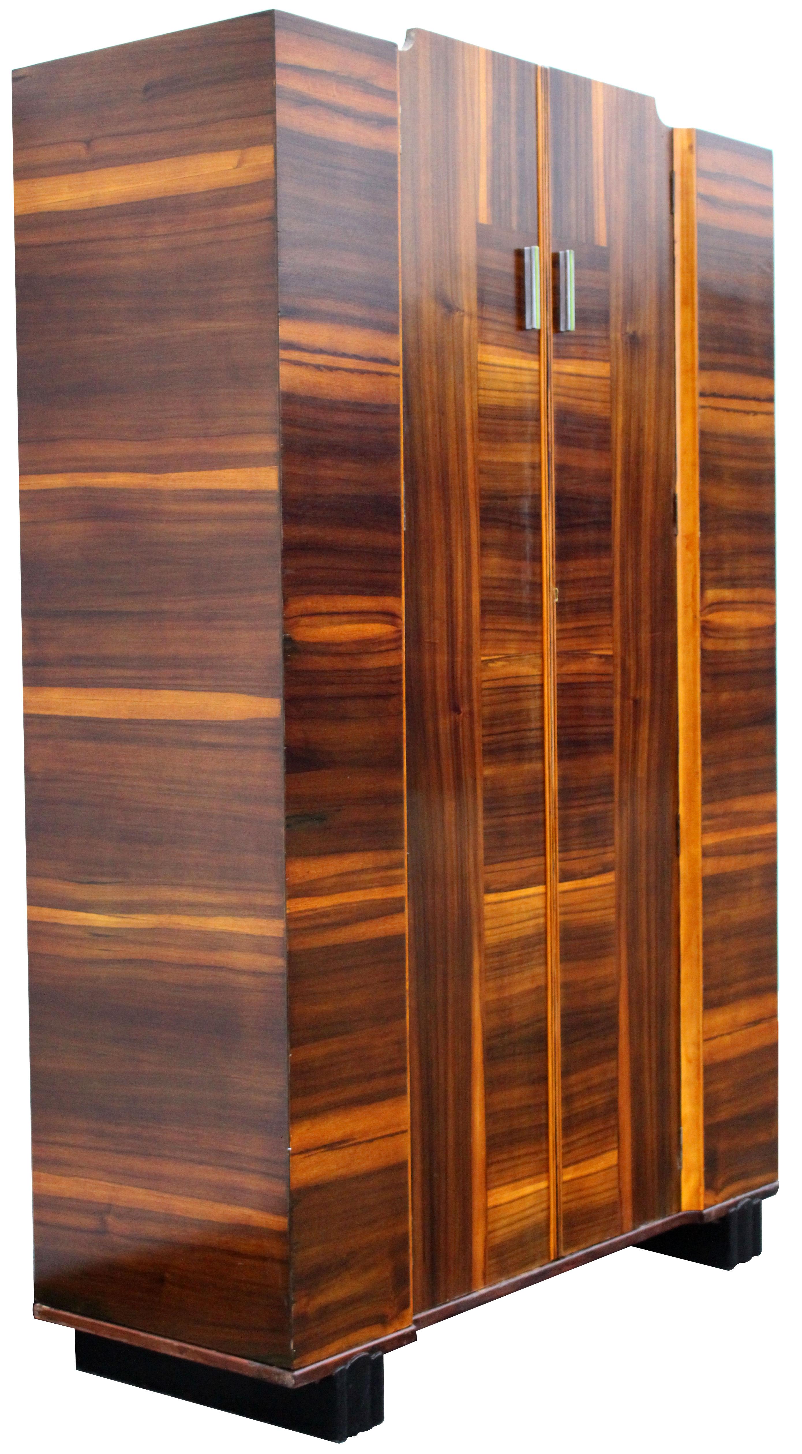 For your consideration is this very striking and imposing Art Deco double wardrobe with a modernist slant. The veneers are wonderful offering light and dark tones. This stand alone wardrobe would fit perfectly in any modern or modernist interior.