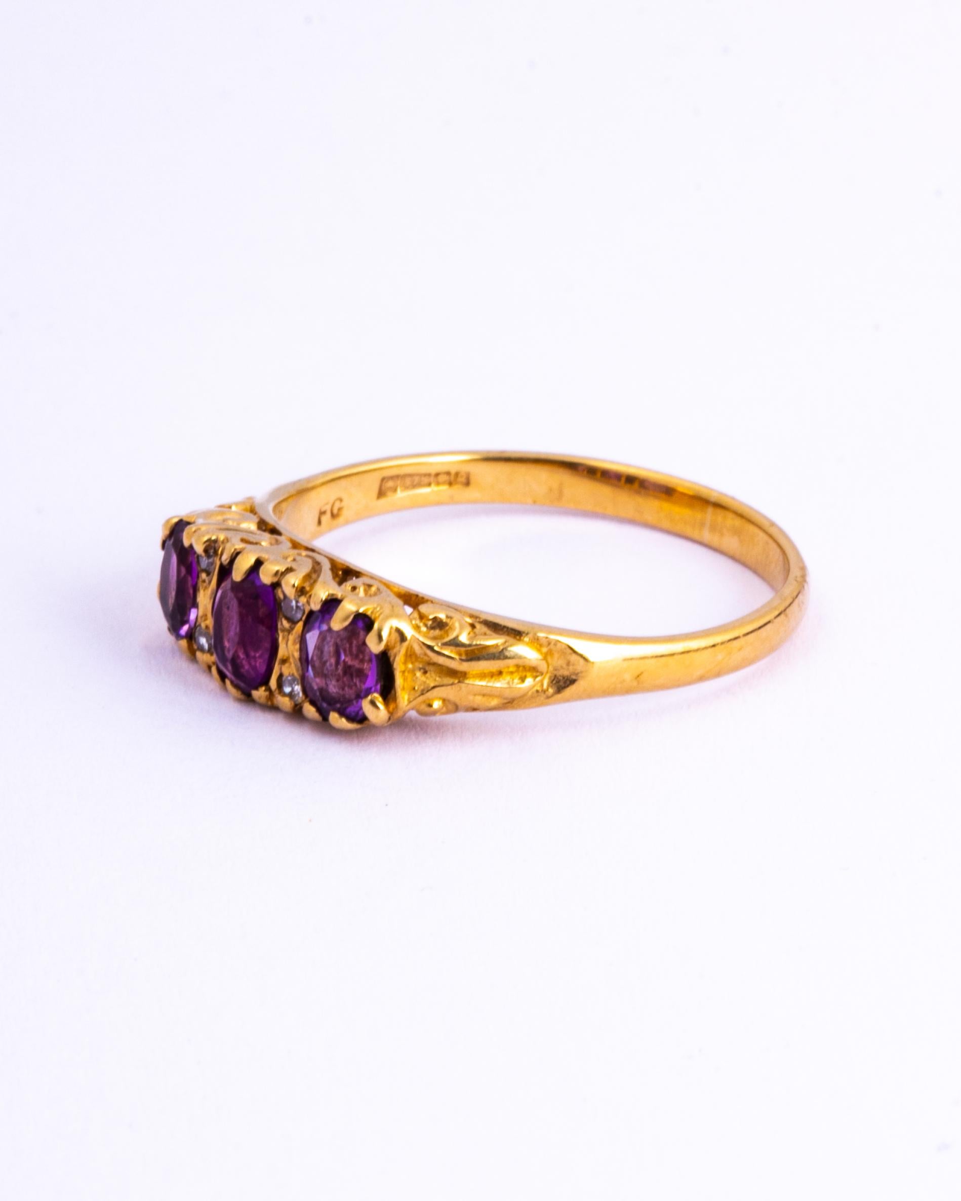 The amethyst stones in this ring are so bright and a gorgeous colour. There are two pairs of diamond points that sit either side of the central stone. Modelled in 9carat gold. 

Ring Size: R or 8 3/4
Band Width: 5.5mm 
Height Off Finger: 4mm