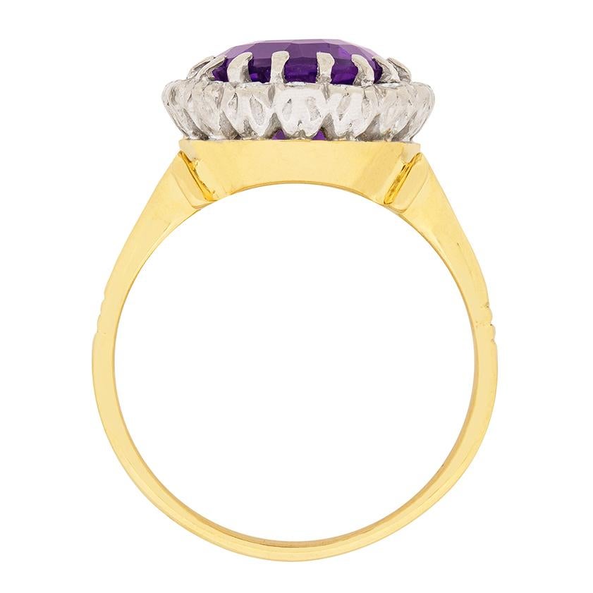 This beautiful dress ring features a natural amethyst in the centre. The colour is a beautiful deep purple and it weighs 4.50 carat. The halo of diamonds surrounding has a combined weight of 0.32 carat. They are 8-cut diamonds and they have been