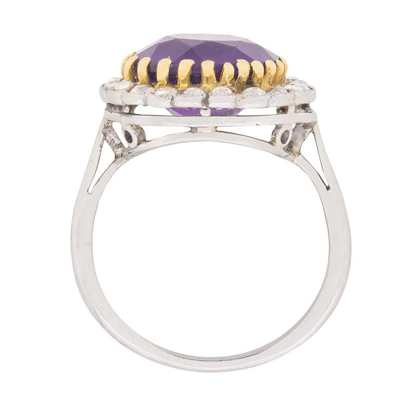 This eye-catching Art Deco era ring contrasting 18 carat yellow gold claws secure a brilliantly-hued 3.00 carat amethyst within a glittering border of old cut diamonds totalling 0.20 carats. Platinum comprises the balance of the ring's c.1920s