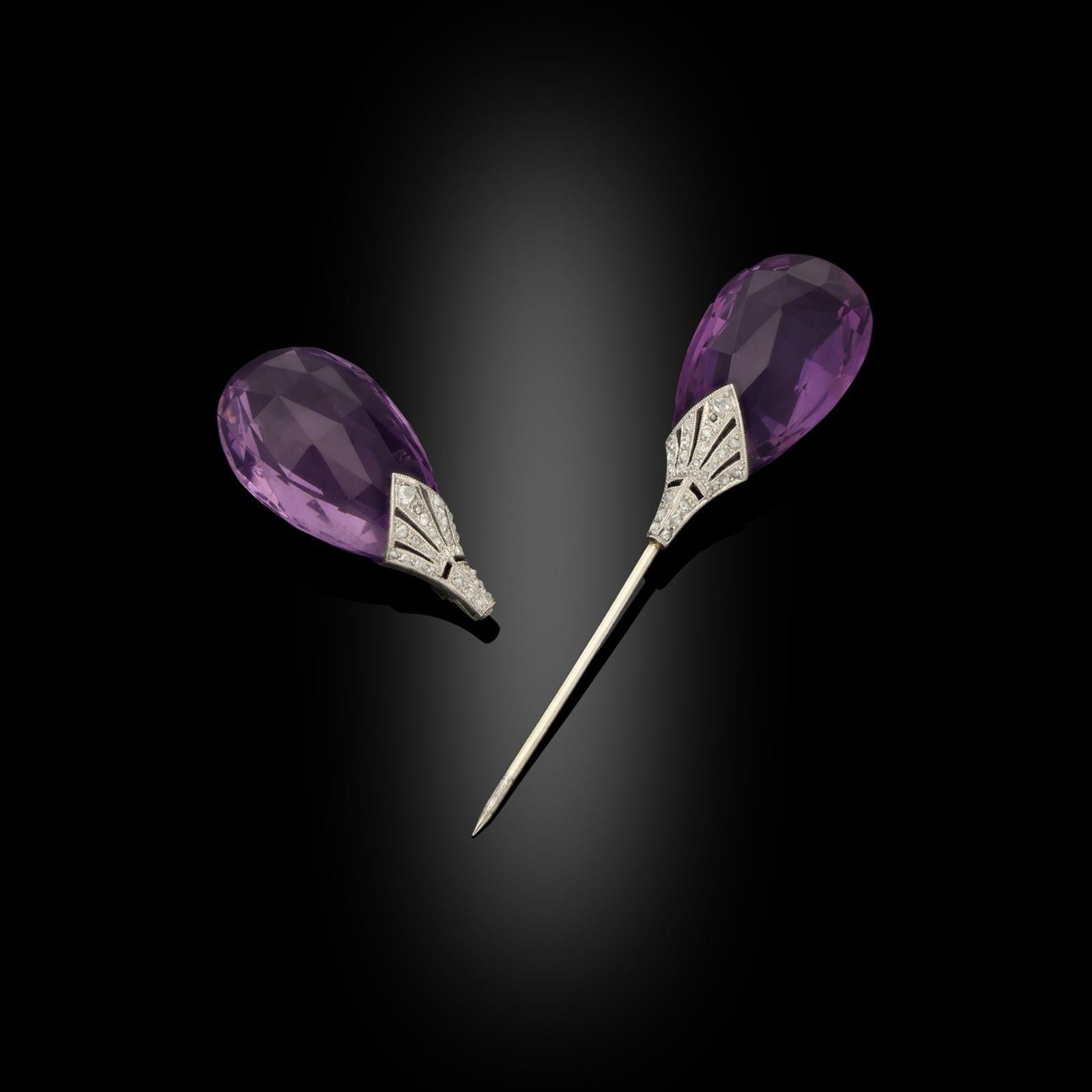 An Art Deco amethyst and diamond jabot pin, circa 1925. This jabot pin brooch is set each end with large pear shaped briolette cut amethysts. The gemstones are connected by a single platinum pin with finely pierced platinum and old cut diamond