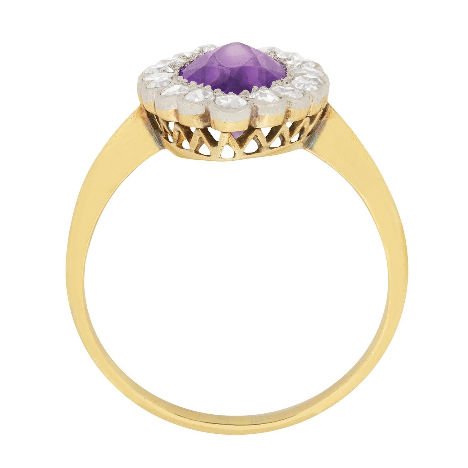 A halo of twinkling old cut diamonds framed in platinum encircles the rich, beautiful 1.50 carat amethyst in its 18 carat yellow gold openwork setting at the centre of this classic 1920s era marquise-shaped ring.

Gemstone: Amethyst
Carat Weight: