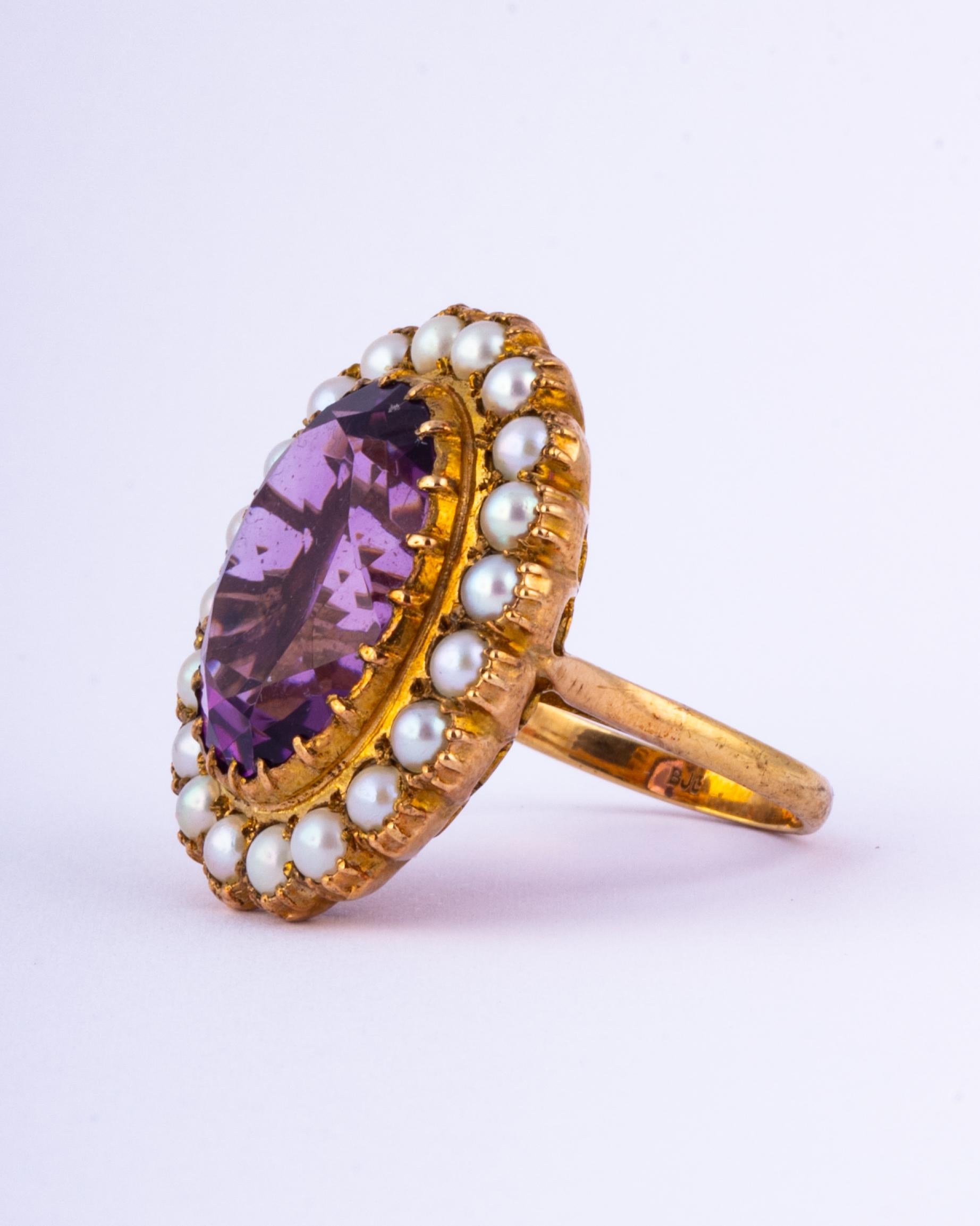 The glossy amethyst at the centre is a gorgeous bright tone of purple. Surrounding it are a halo of small pearls and all stones are set in simple claw settings. The under side of the cluster is absolutely stunning and is classic art deco! 

Ring