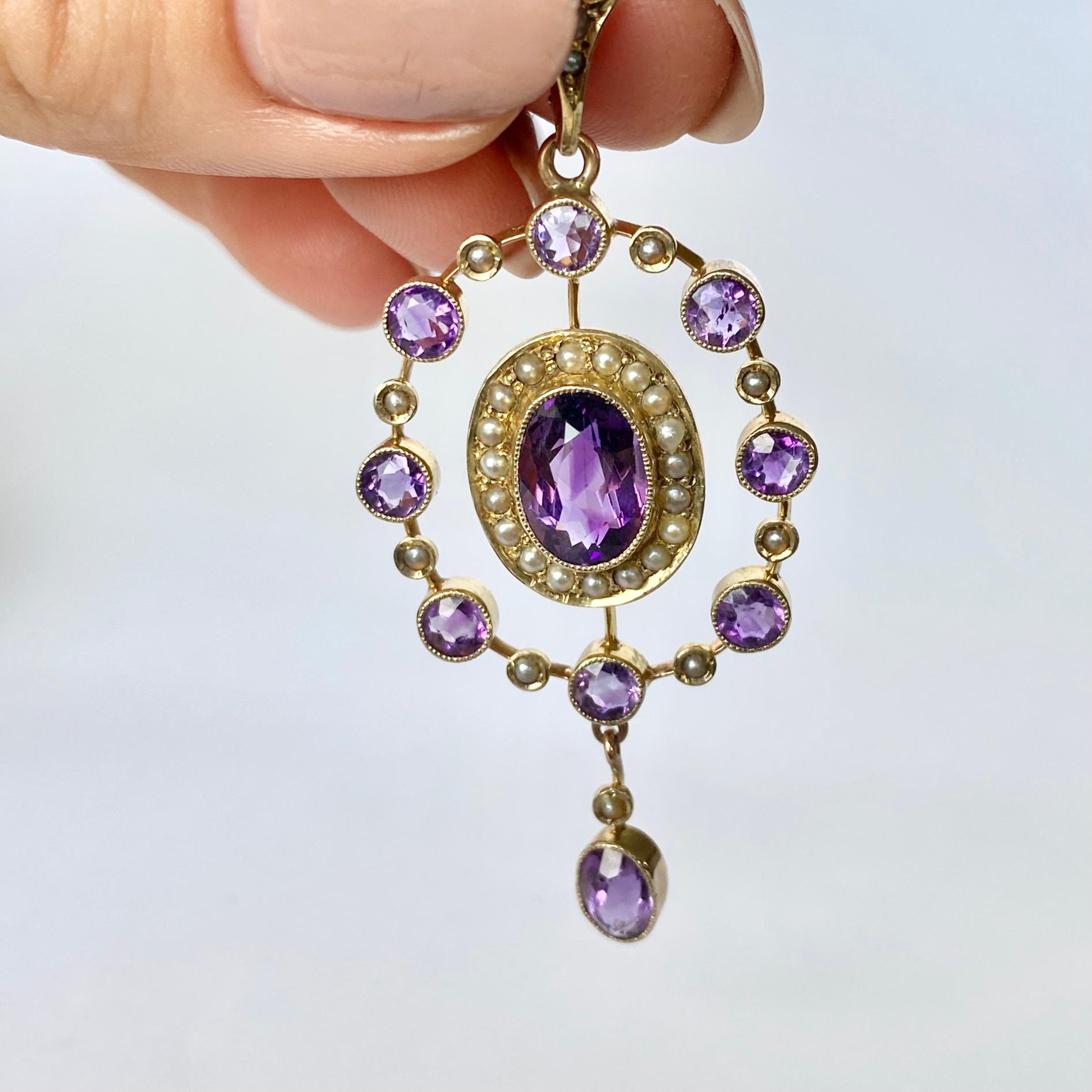 The style of this pendant is so delicate with the fine metal work and is beautifully decorated with pearls and amethyst. The central round amethyst measures 2ct.  Modelled in 9carat gold. 

Pendant Drop From Loop: 56mm

Weight: 5g 