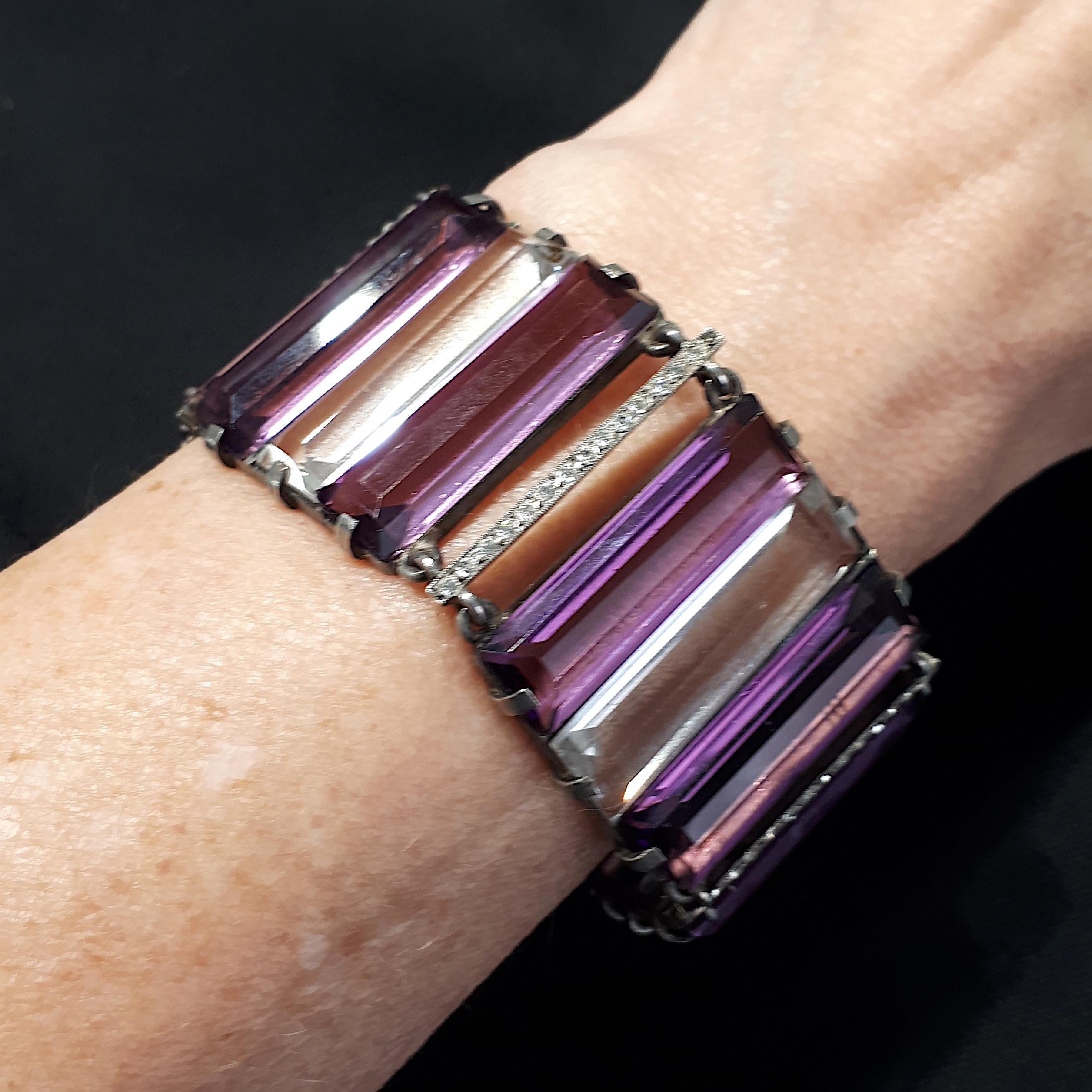 A French Art Deco amethyst, rock crystal and eight-cut paste bracelet, with three stone groups of two large baguette-cut amethysts with rock crystal in the middle, with paste set spacers between, mounted in silver, with French marks for silver,