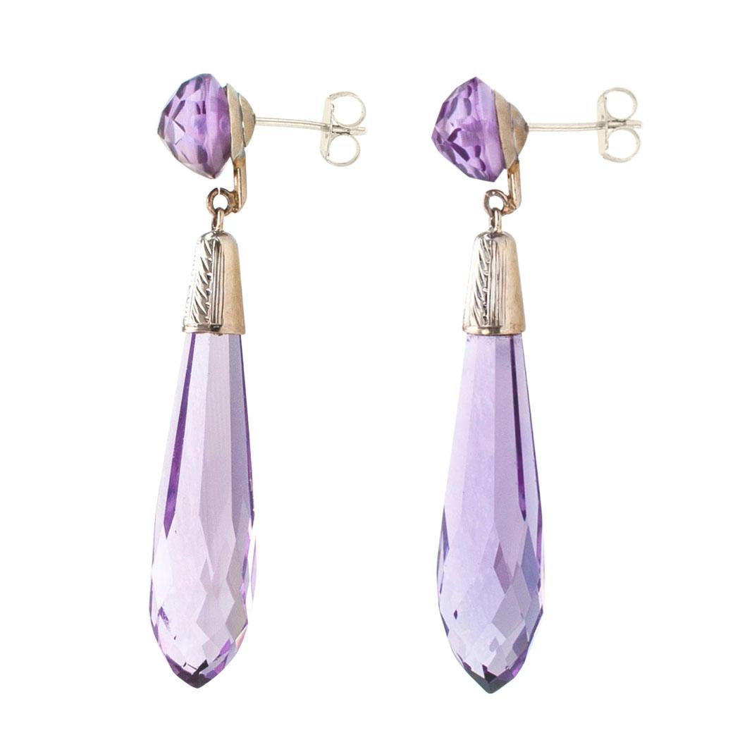 Art Deco amethyst briolette and white gold drop earrings circa 1925. The matching designs feature a pair of briolette amethyst with white gold caps decorated with chase work, suspended from round, briolette faceted surmounts, mounted in 14-karat