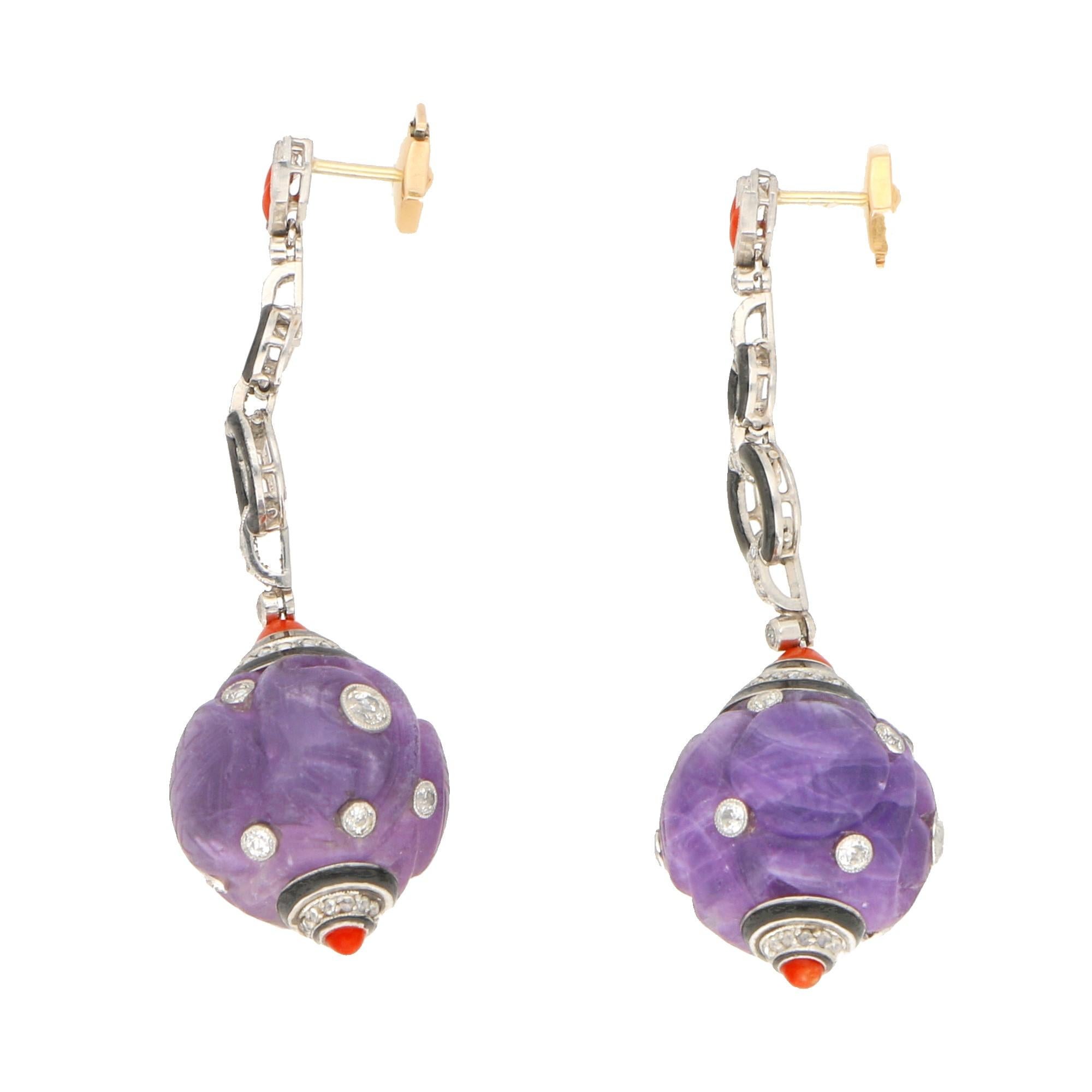 A fine pair of Art Deco amethyst, diamond, coral and enamel drop earrings in platinum, French, circa 1930. Each earring featuring a carved boule amethyst encrusted with twelve millegrain-set Old European brilliant-cut and Transitional round