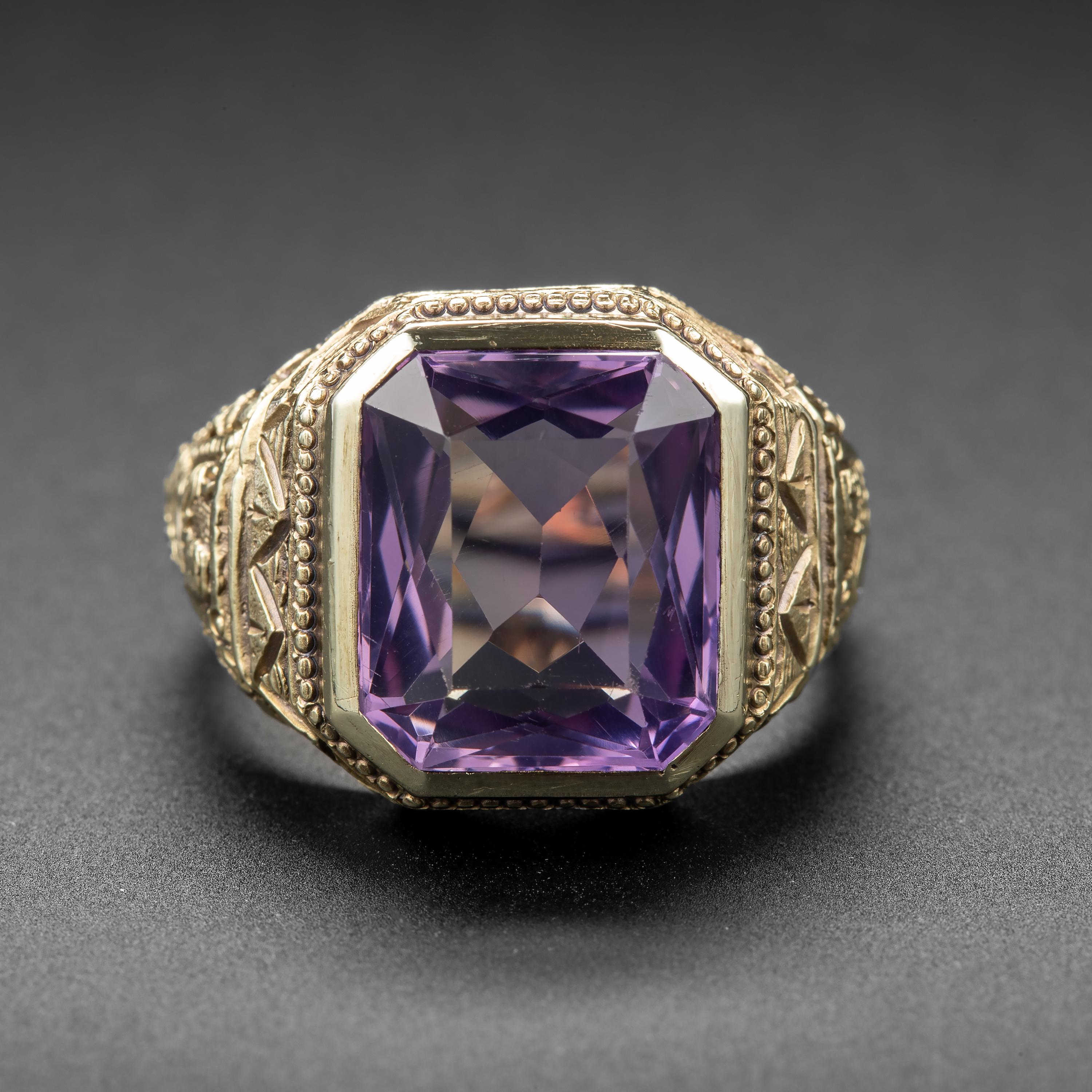 A bold and beautiful Egyptian Revival statement ring from the Art Deco era. Crafted by hand in 14k yellow gold, the ring showcases a beautiful rectangular-cut amethyst that measures approximately 14.40mm x 11.84mm and weighs about 8.79 carats. The