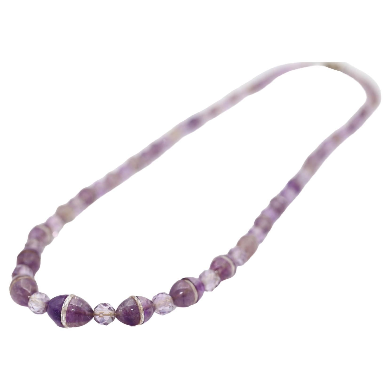 Art Deco Necklace comprising of Amethysts and  Rock Crystal Beads. Created around the 1920s. The necklace is quite heavy and has a fine presence to it. It can also be worn like a bracelet wrapped around a hand several times. You can have fun time