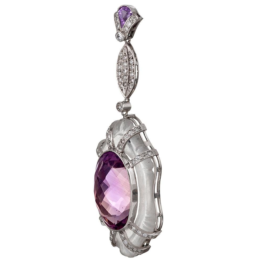 These striking platinum ear pendants are created of faceted amethyst with carved rock crystal and diamond accents. Note the sculpted finials from which the larger sections are suspended and the manner in which the strands of diamonds contain the